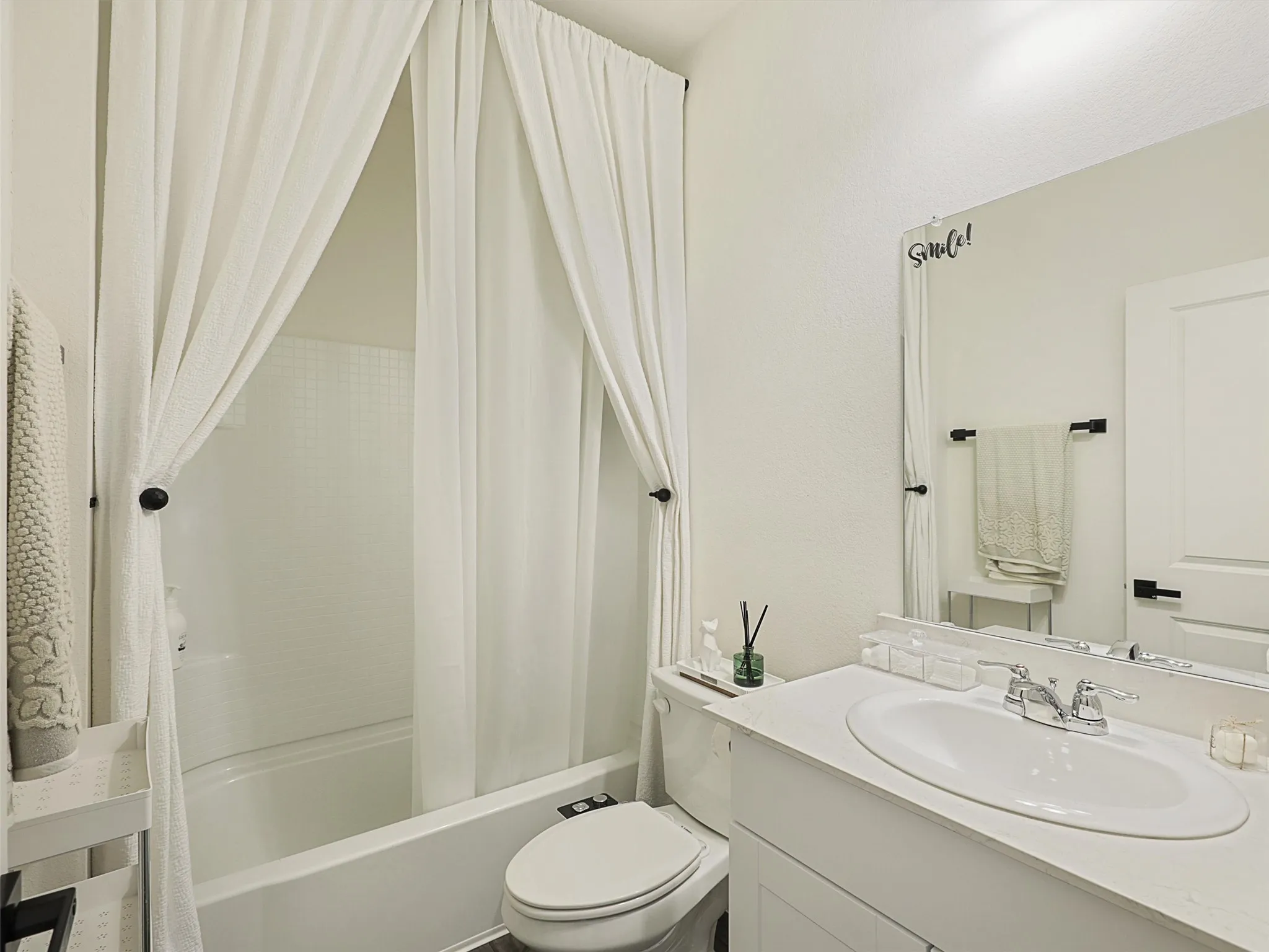 Nearby is the second full bathroom with a tub and shower combination.