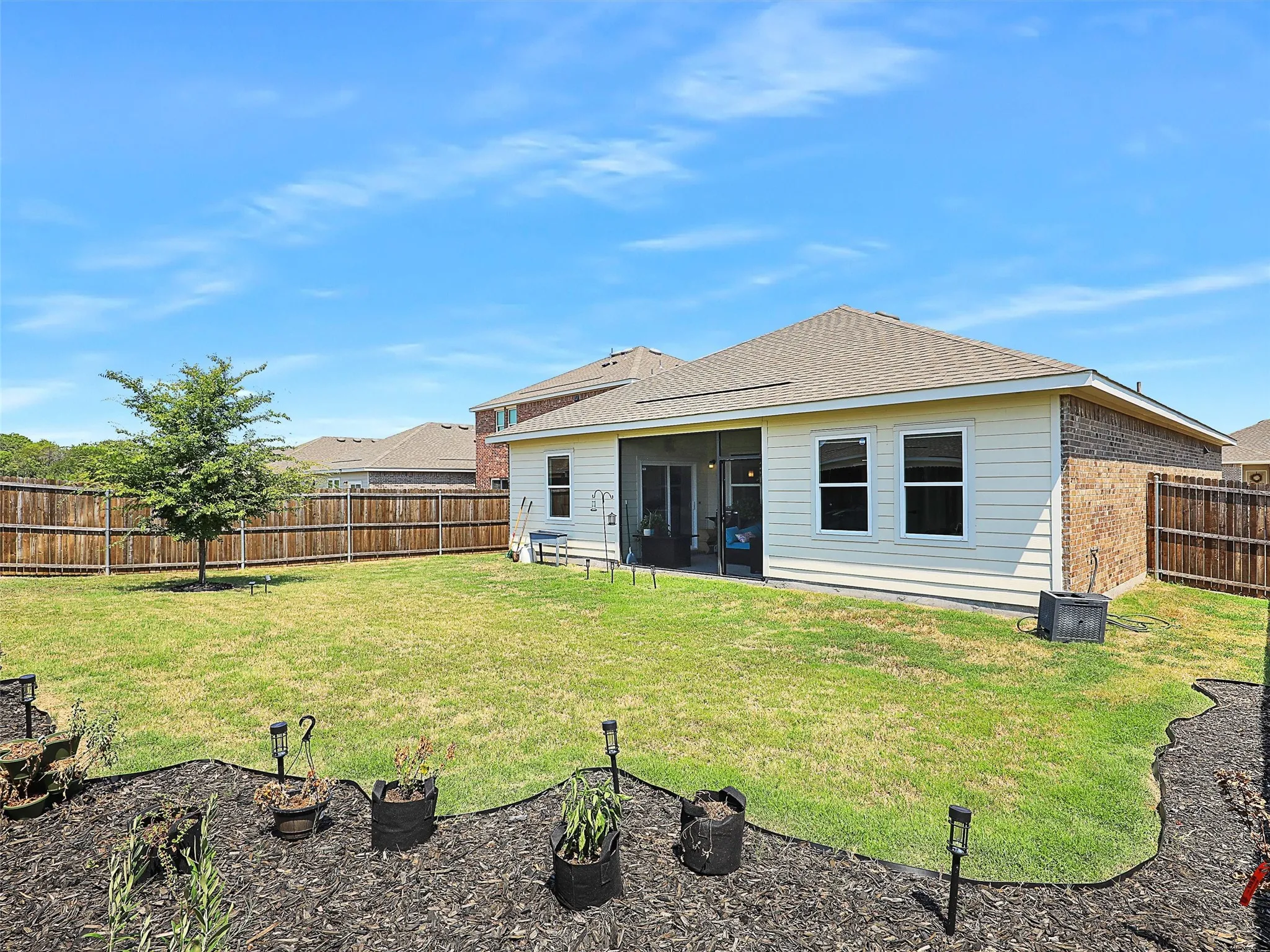 From the backyard, the screened-in porch gives you a covered spot to sit back and enjoy the outdoors.