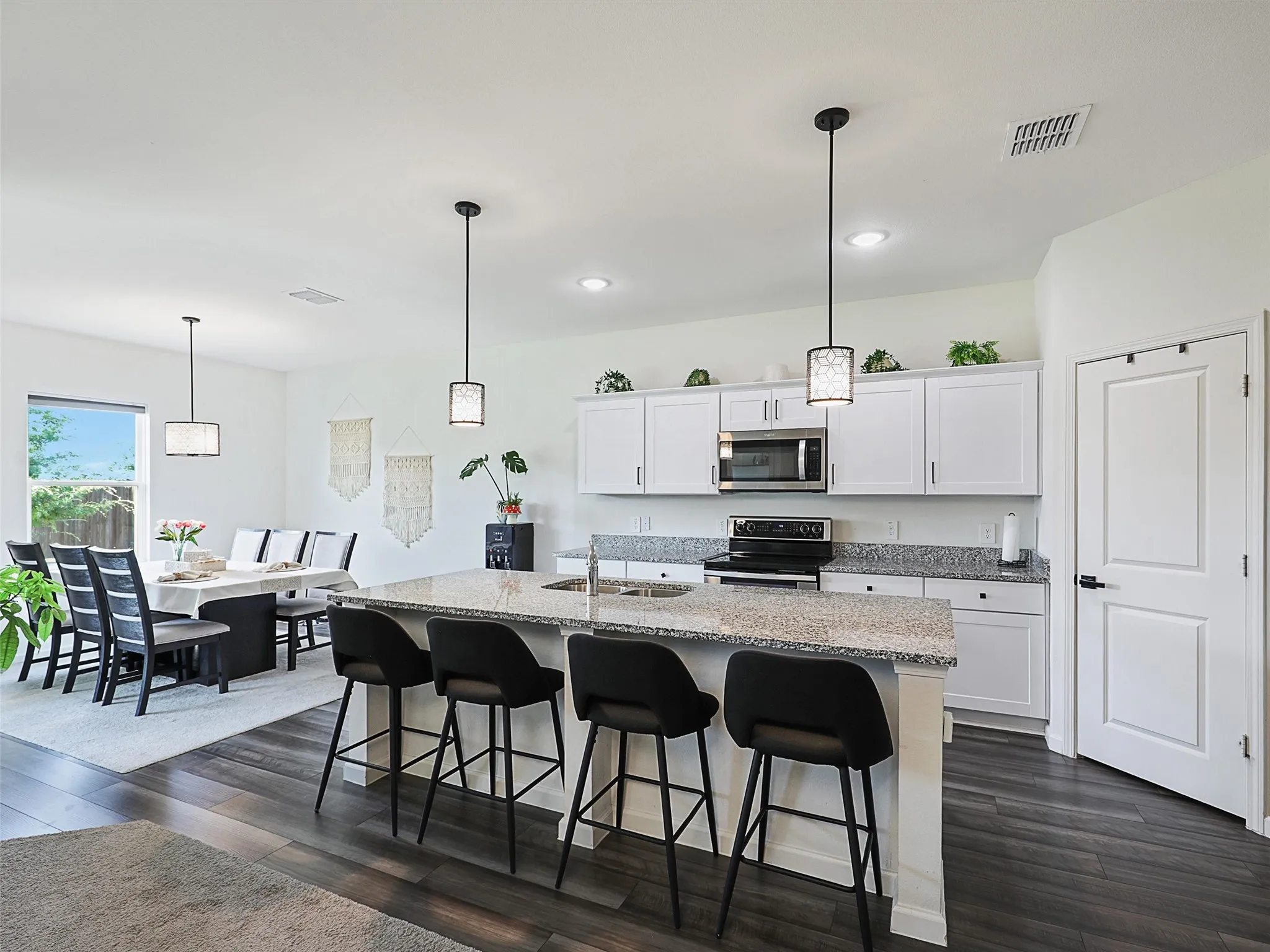 The kitchen features a large center island with seating.
