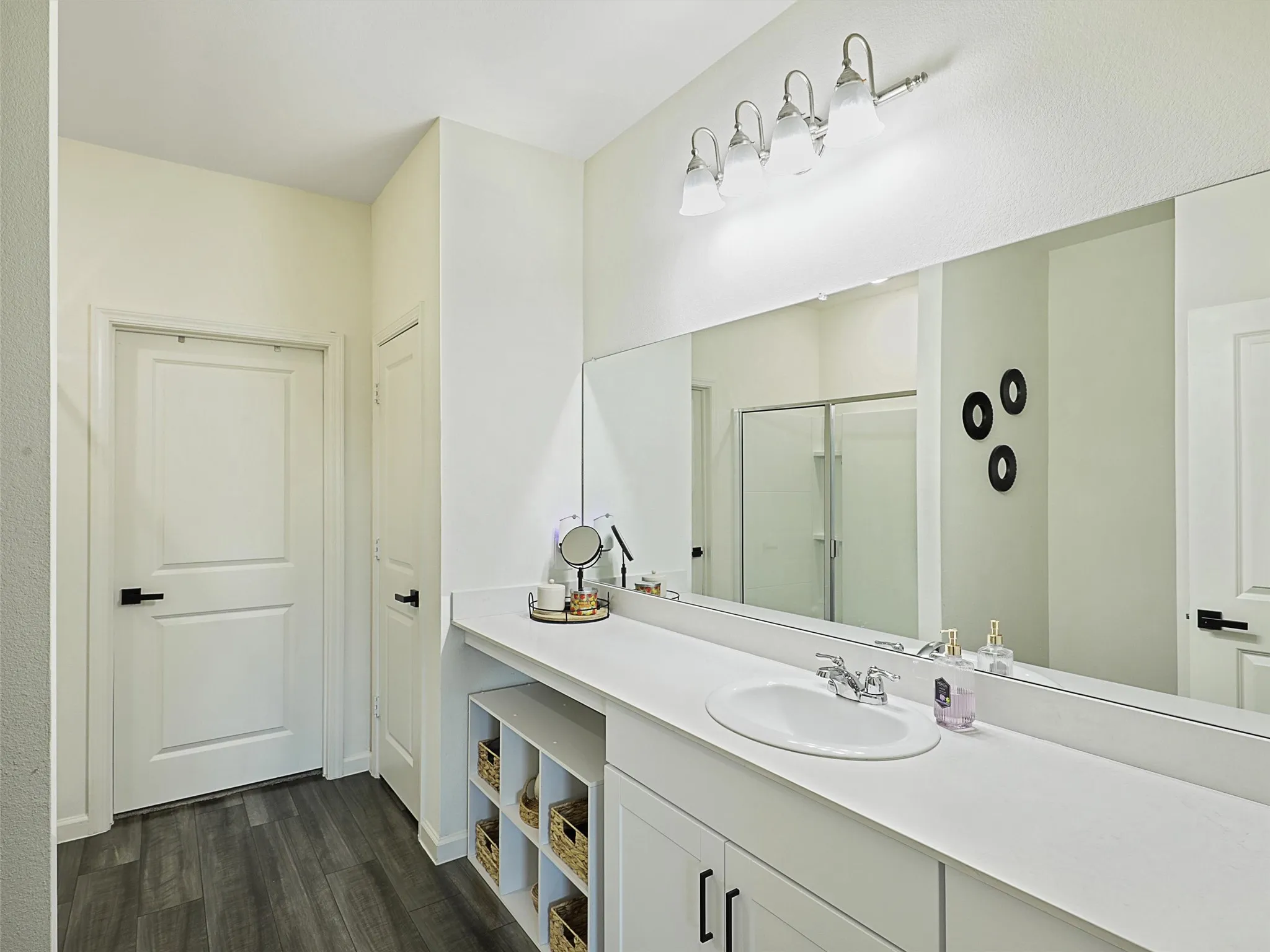 The primary bathroom features a long vanity with plenty of counter and cabinet space.