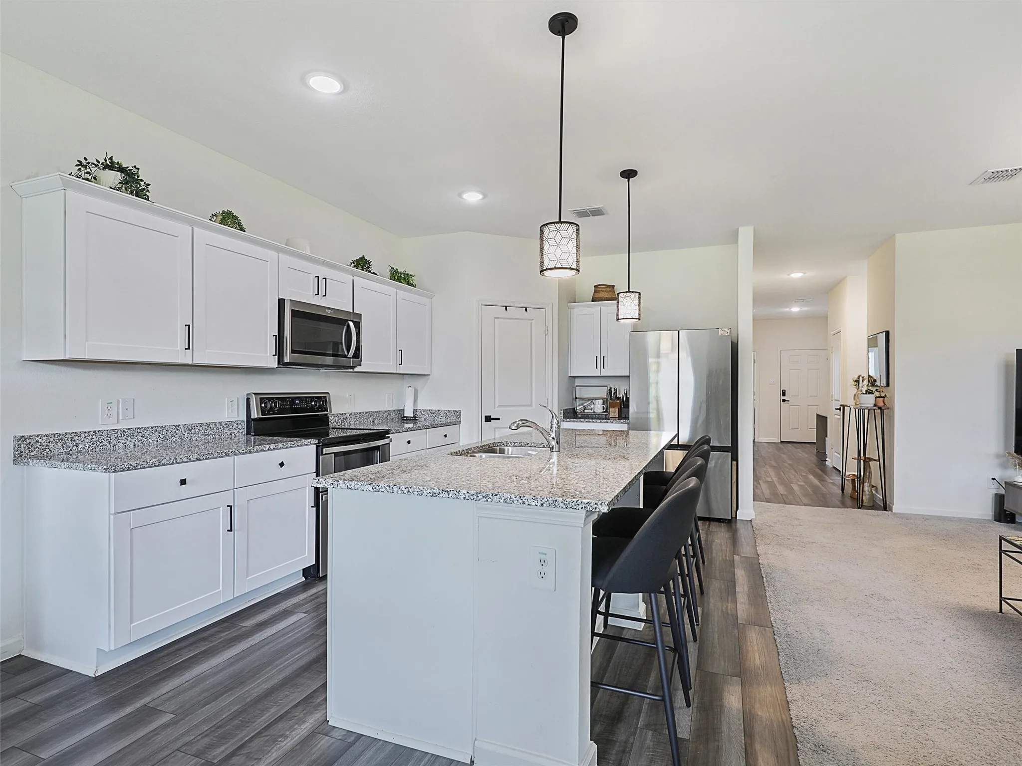 Cabinets and additional counter space continue throughout the kitchen.