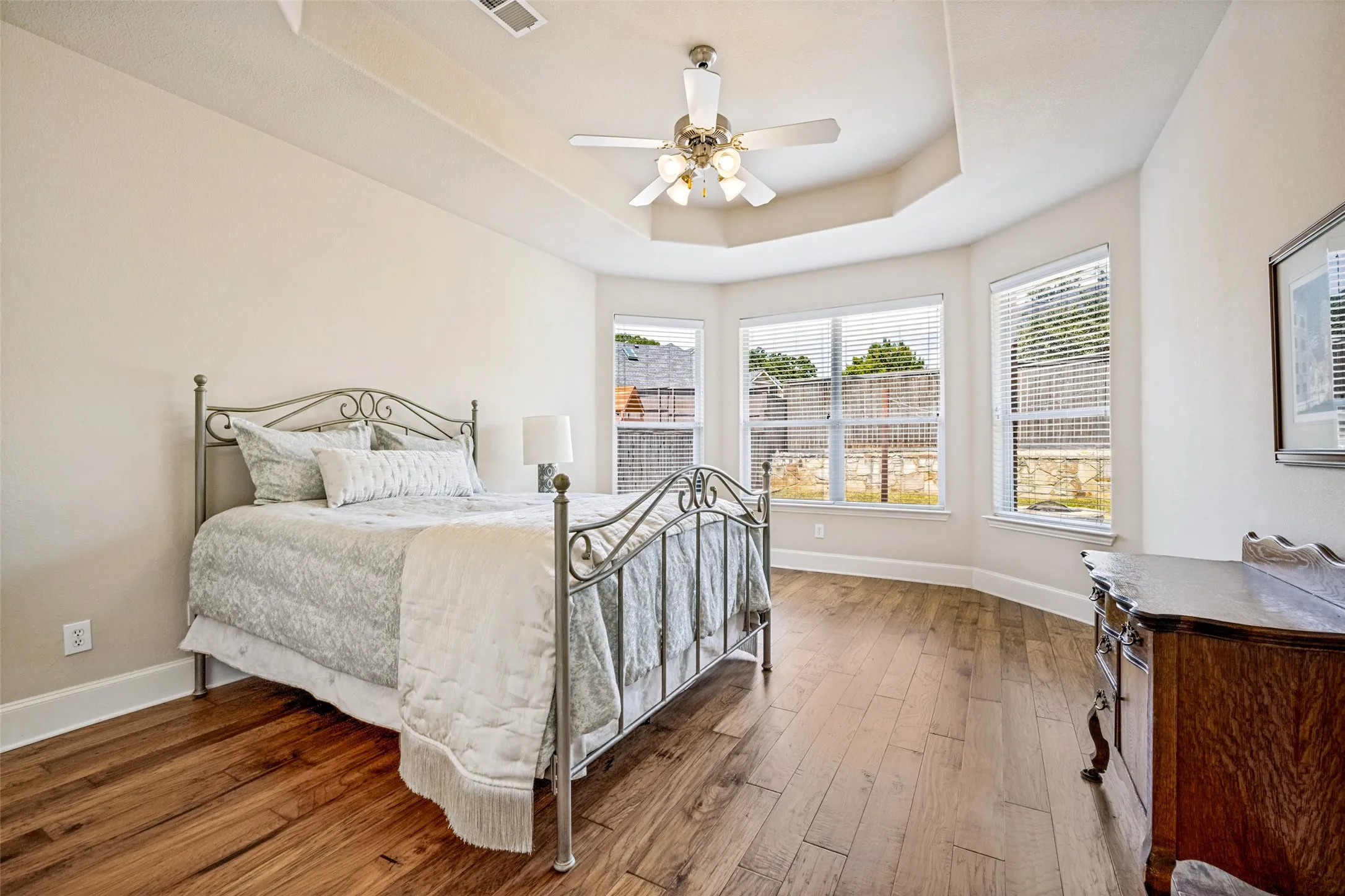 Gorgeous wood floors with sitting area by bay windows