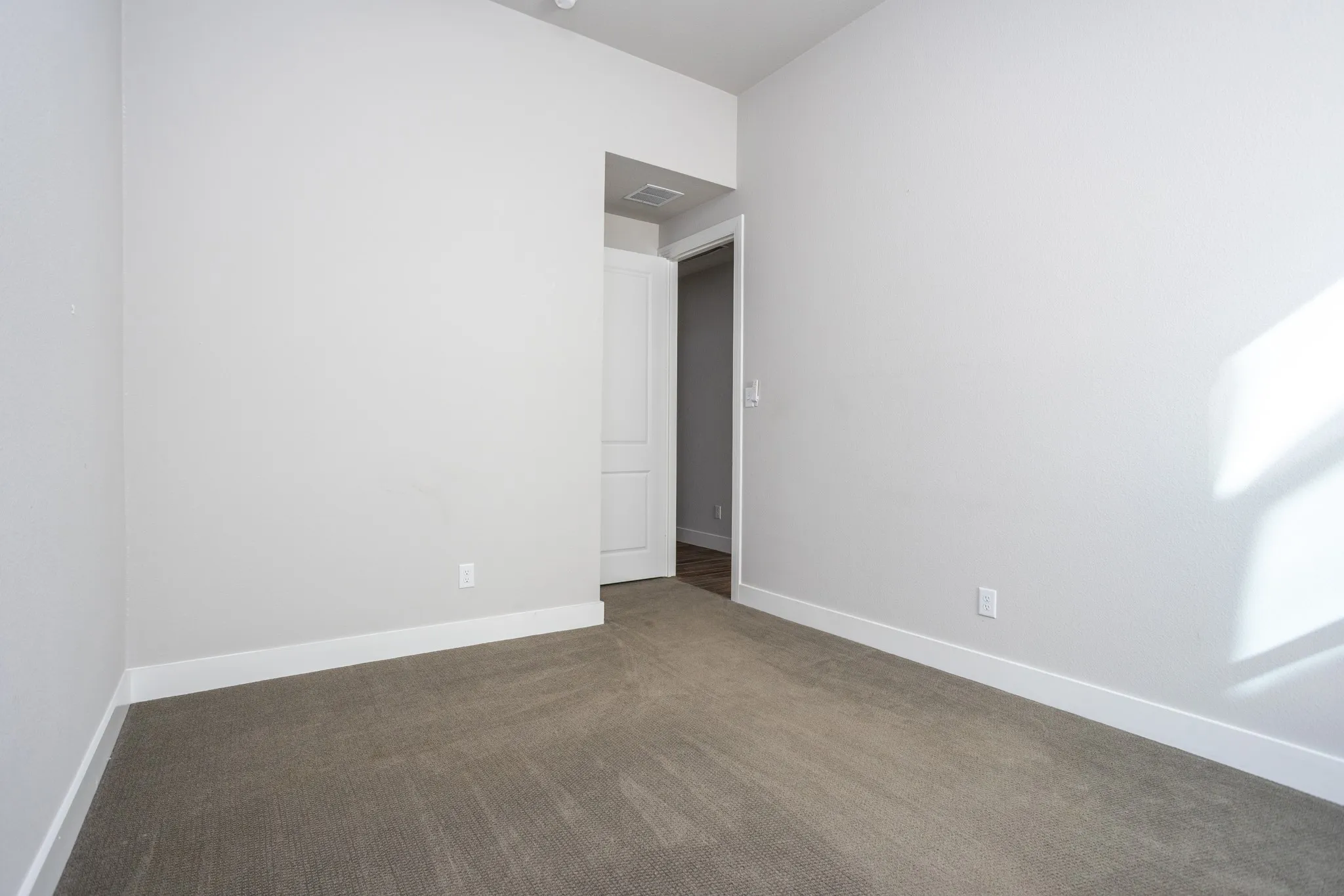 Neutral-toned wall paint and carpeted flooring