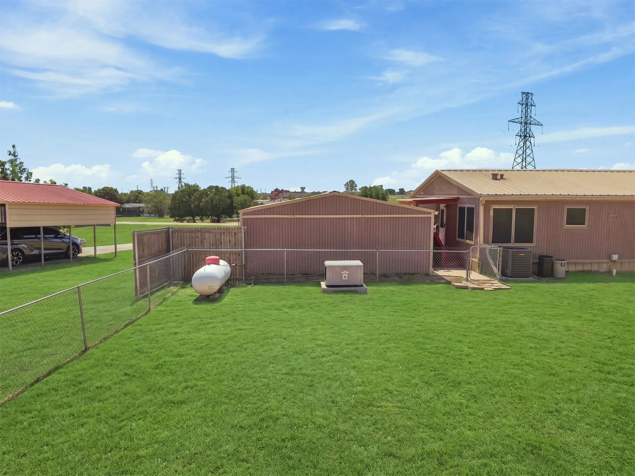 Texas Sized backyard with chain link fencing. Home comes with a generator and propane tank.