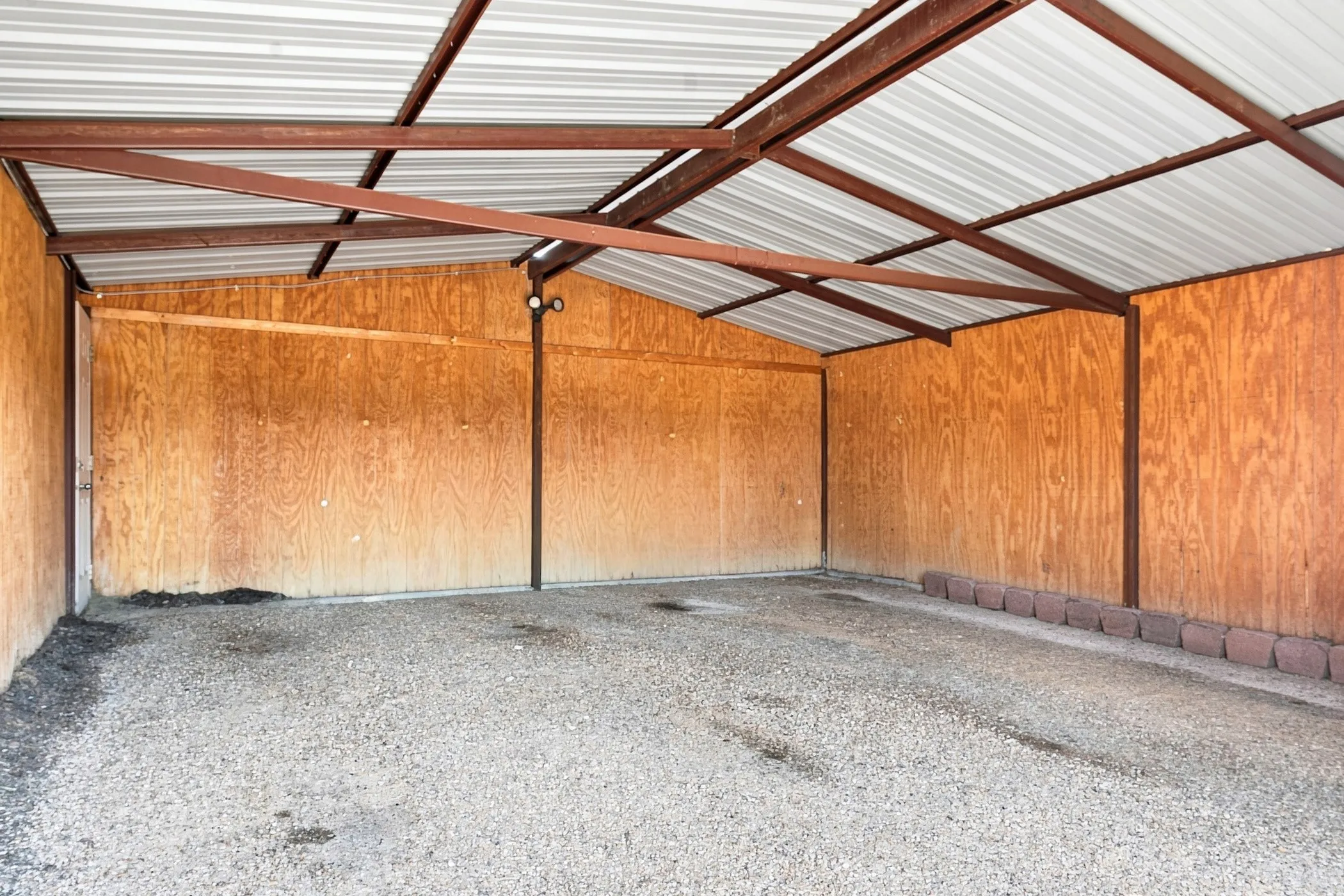 Inside view of the  large detached garage with roll up doors -fits two large trucks nicely