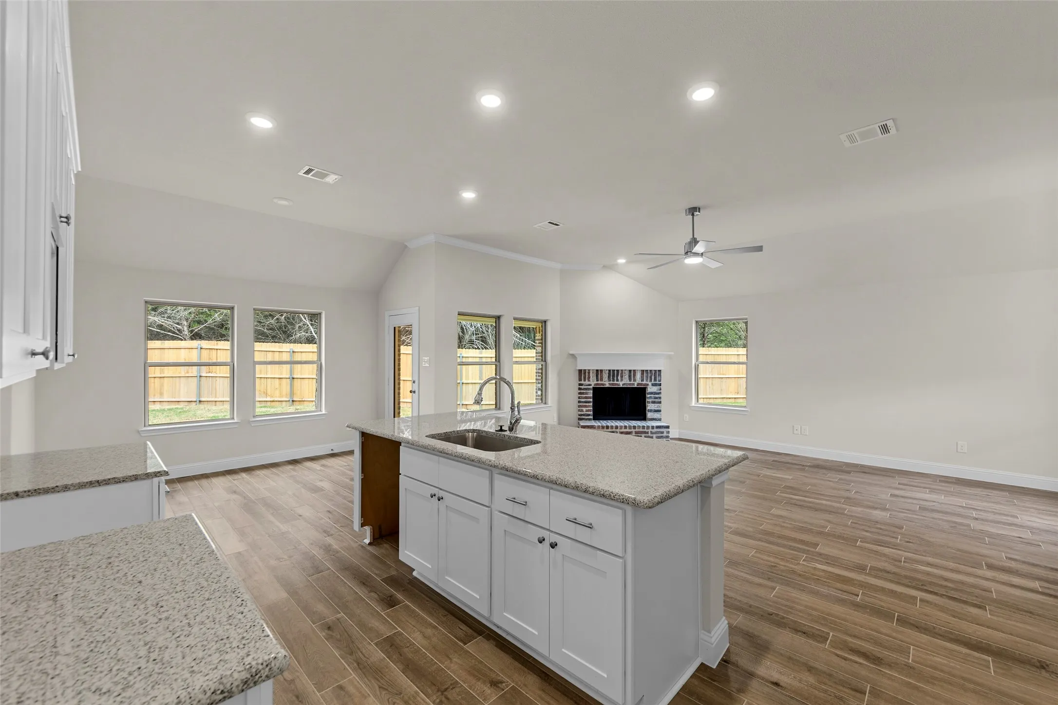 Kitchen island with an undermount sink and granite-finish countertop
