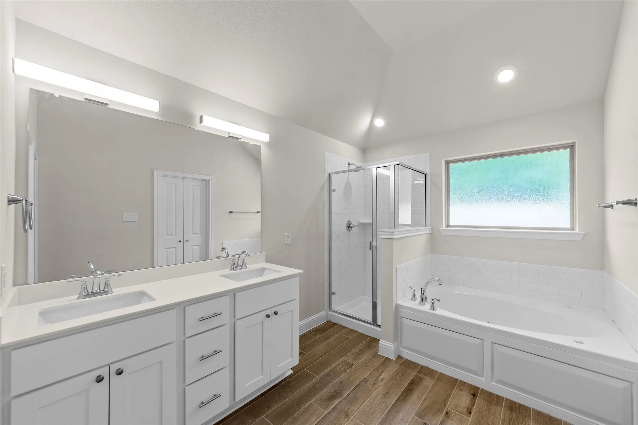 Dual vanity with undermount sinks and white shaker cabinetry