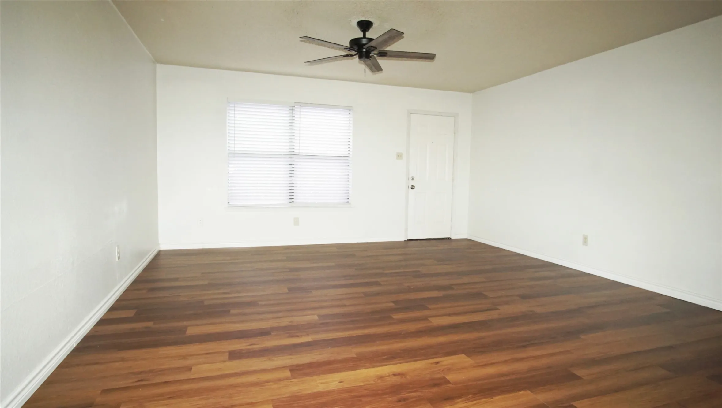 Spare room featuring wood finished floors and ceiling fan