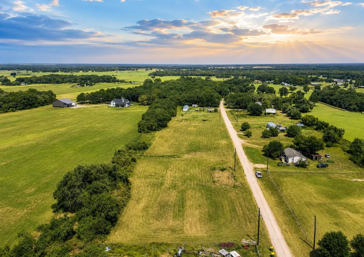 Expansive green fields with scattered mature trees