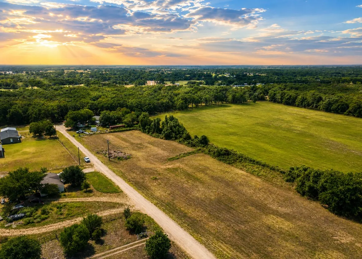 Expansive acreage featuring a mix of cleared pasture and mature tree lines