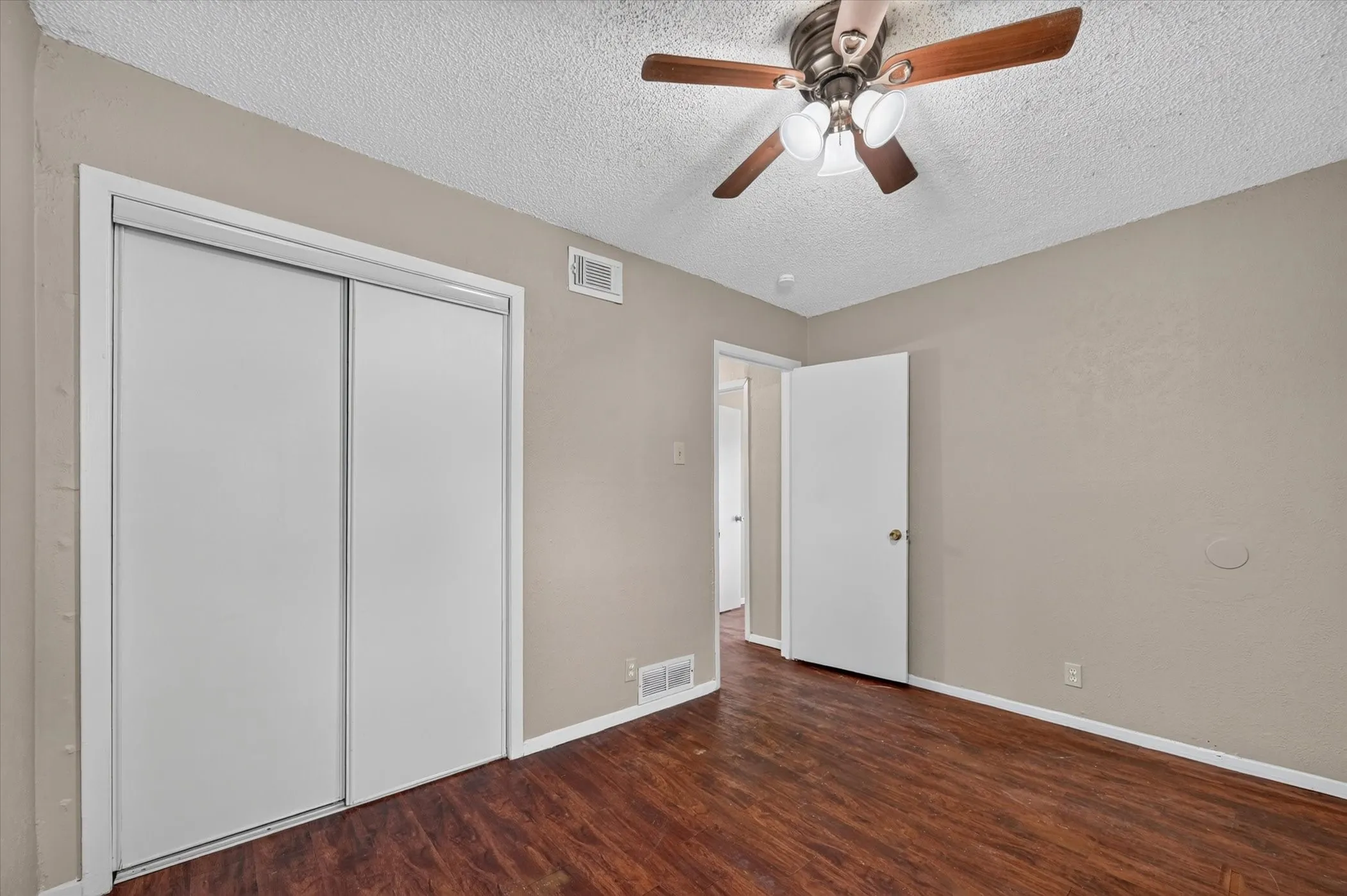 Neutral-toned walls complement the wood-finish flooring
