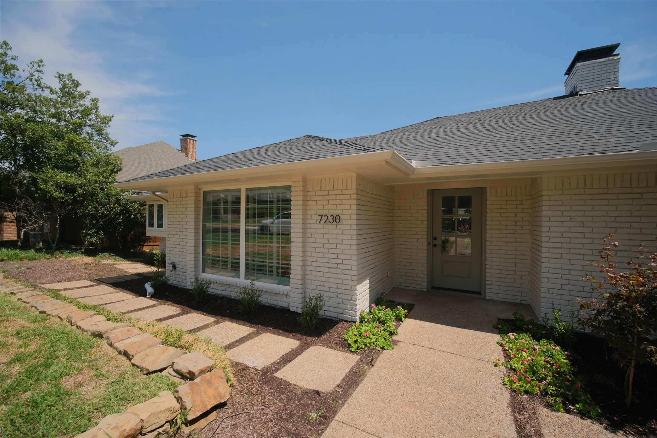 Brick exterior with a gabled roof and a chimney