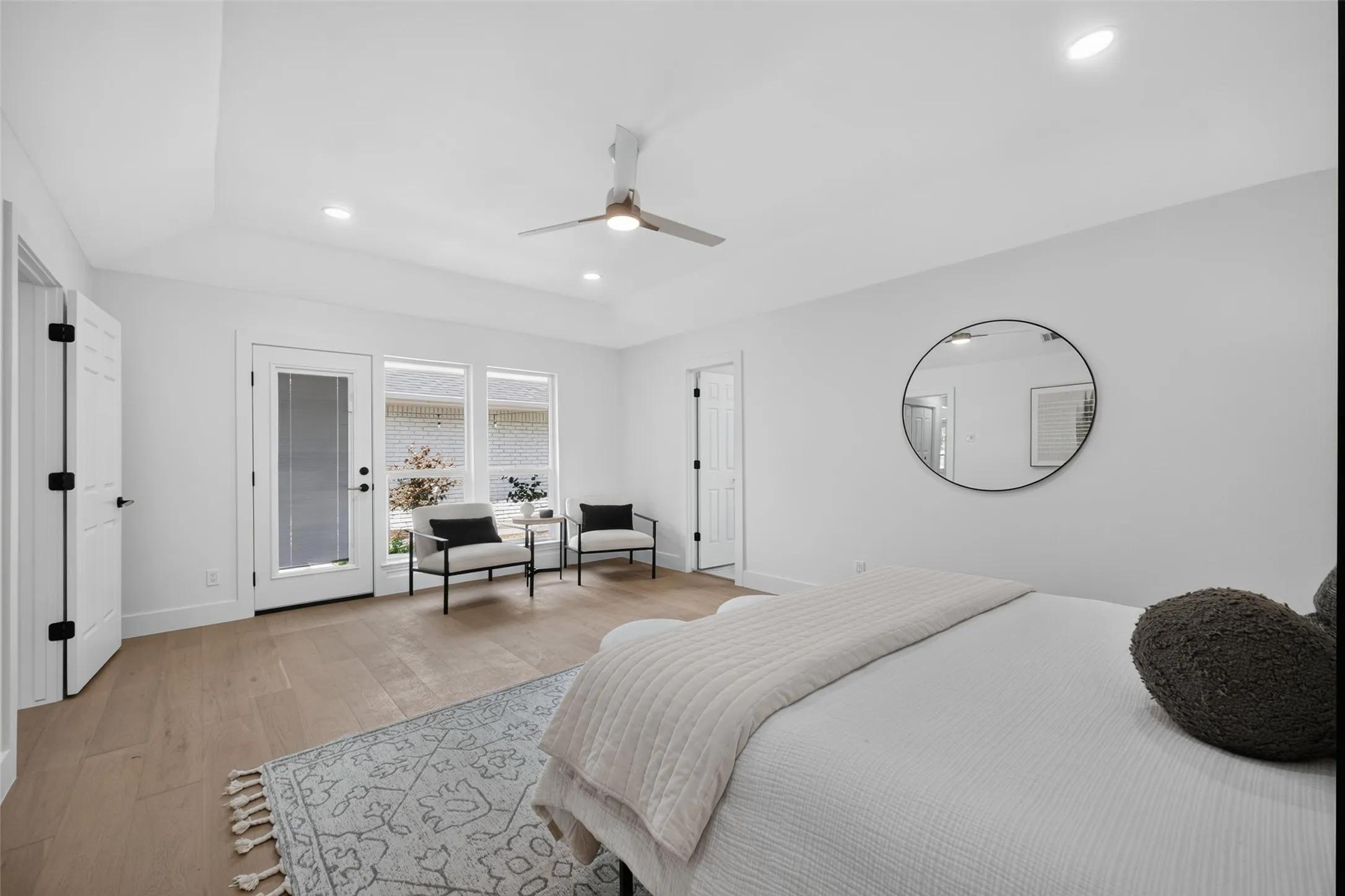Vaulted ceiling with recessed lighting, wood-finish flooring, ceiling fan, and access to exterior
