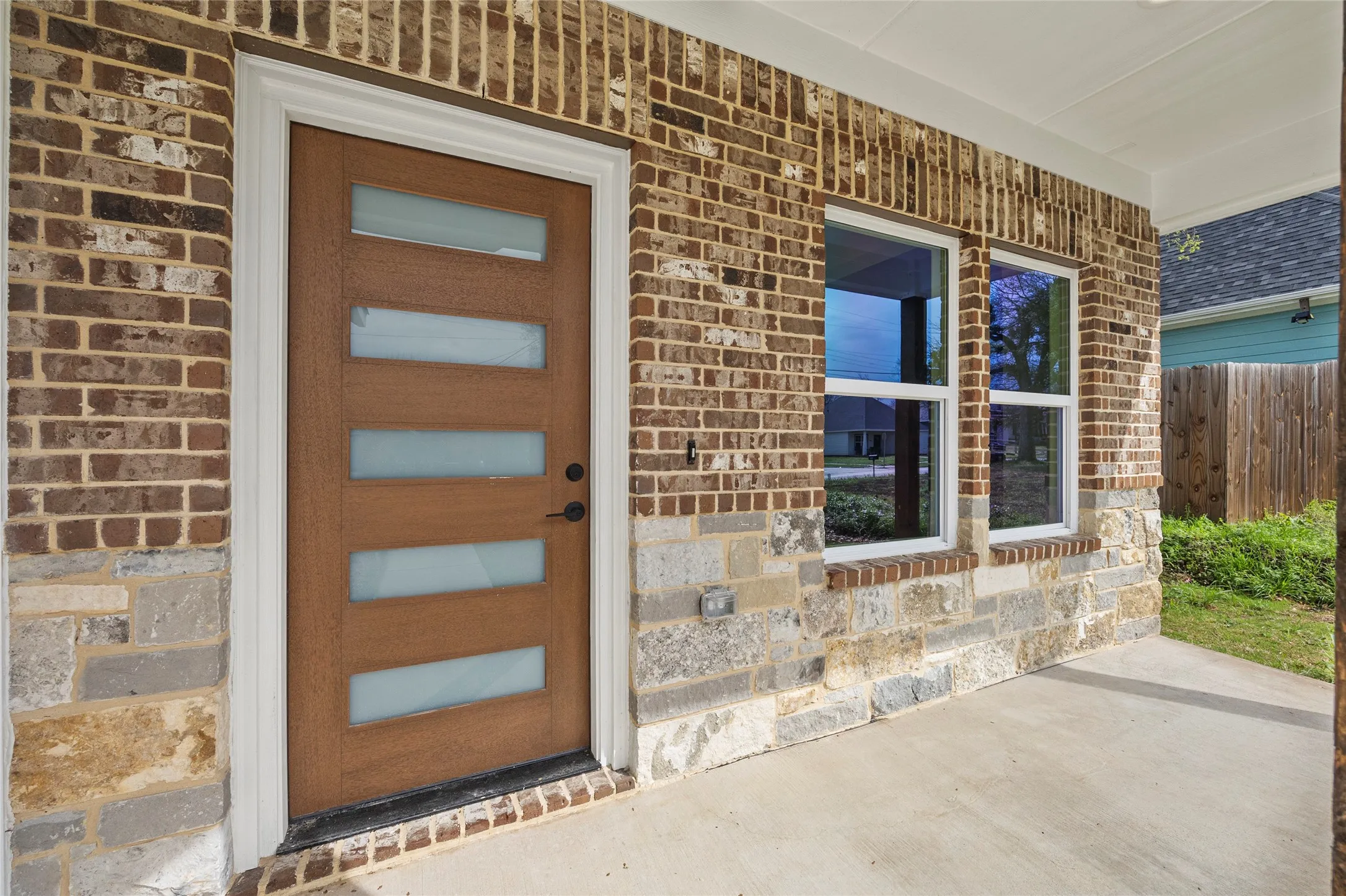 Wood-finish entry door with frosted glass panels