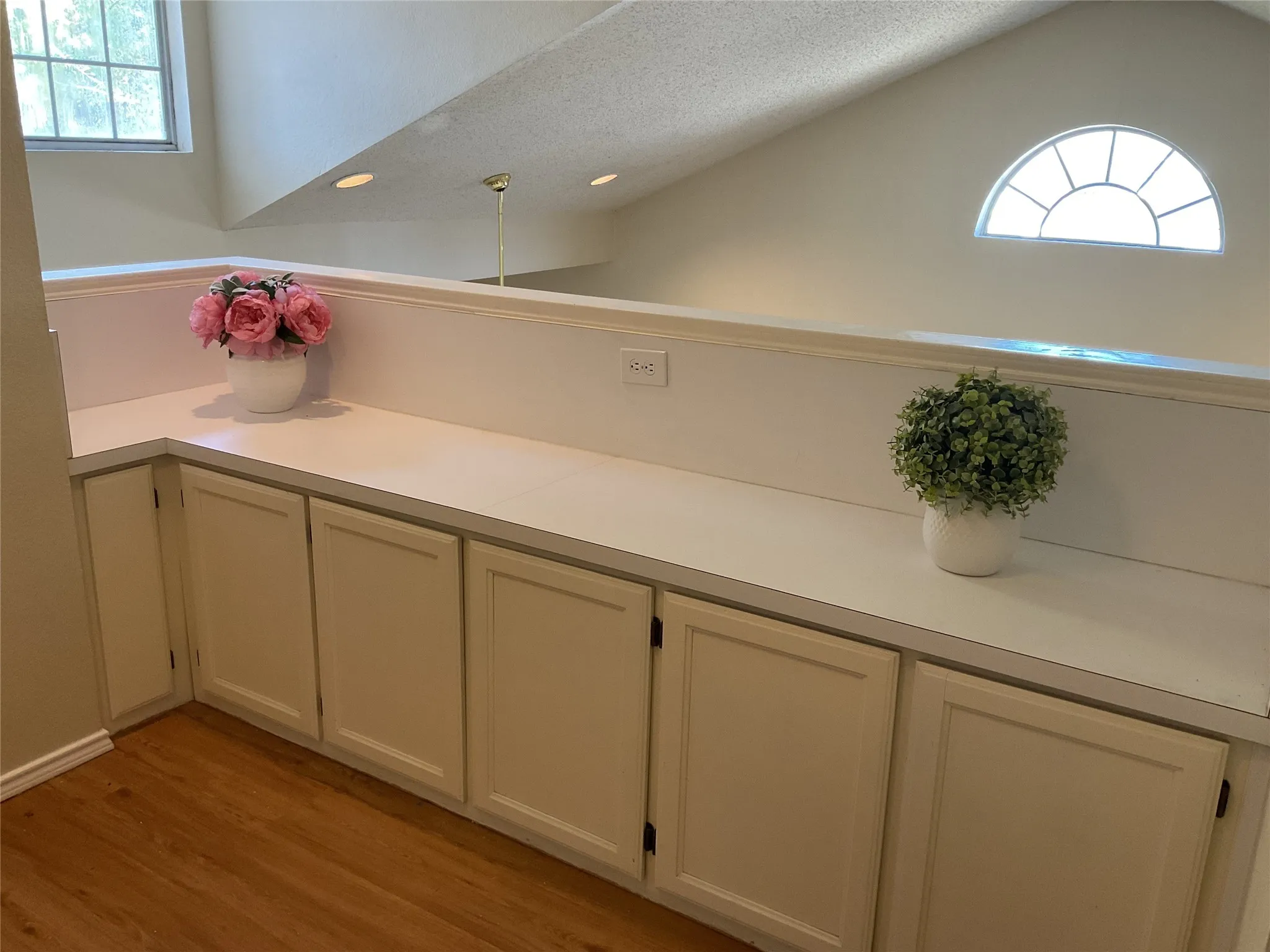 the bonus room at the top of the stairs with ample storage
