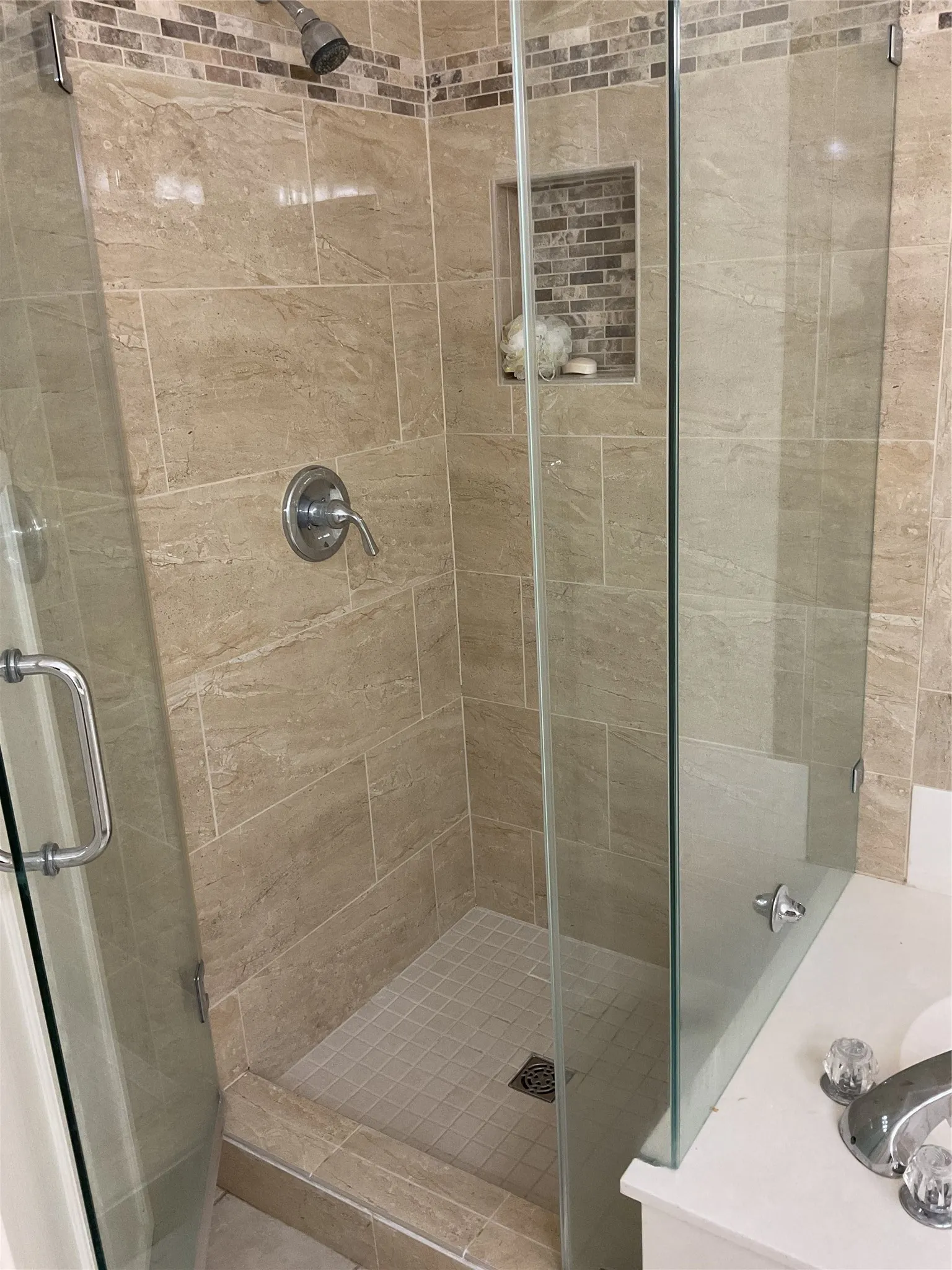 primary bathroom shower standing tile and glass shower