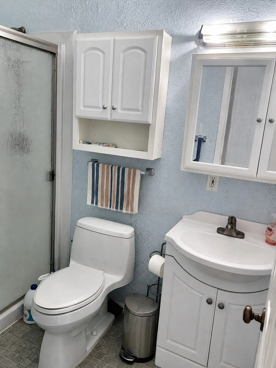 White vanity with an integrated sink and base cabinet