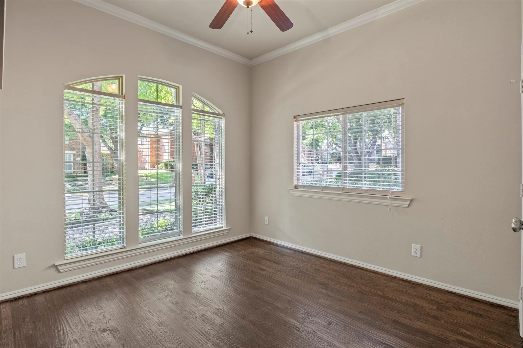 Main level guest bedroom with hardwood floors.