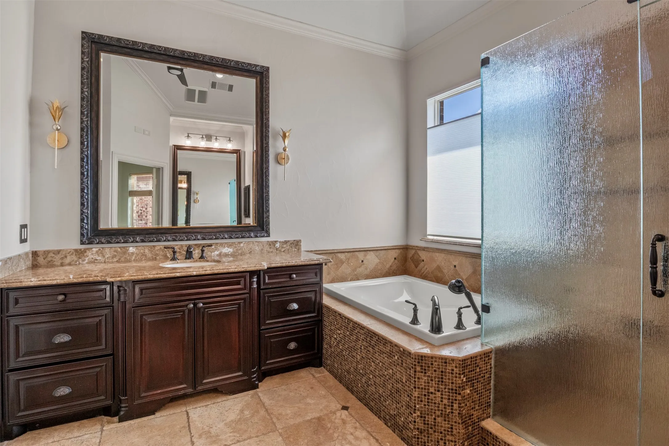 Separate vanities, large window, rain glass shower doors.