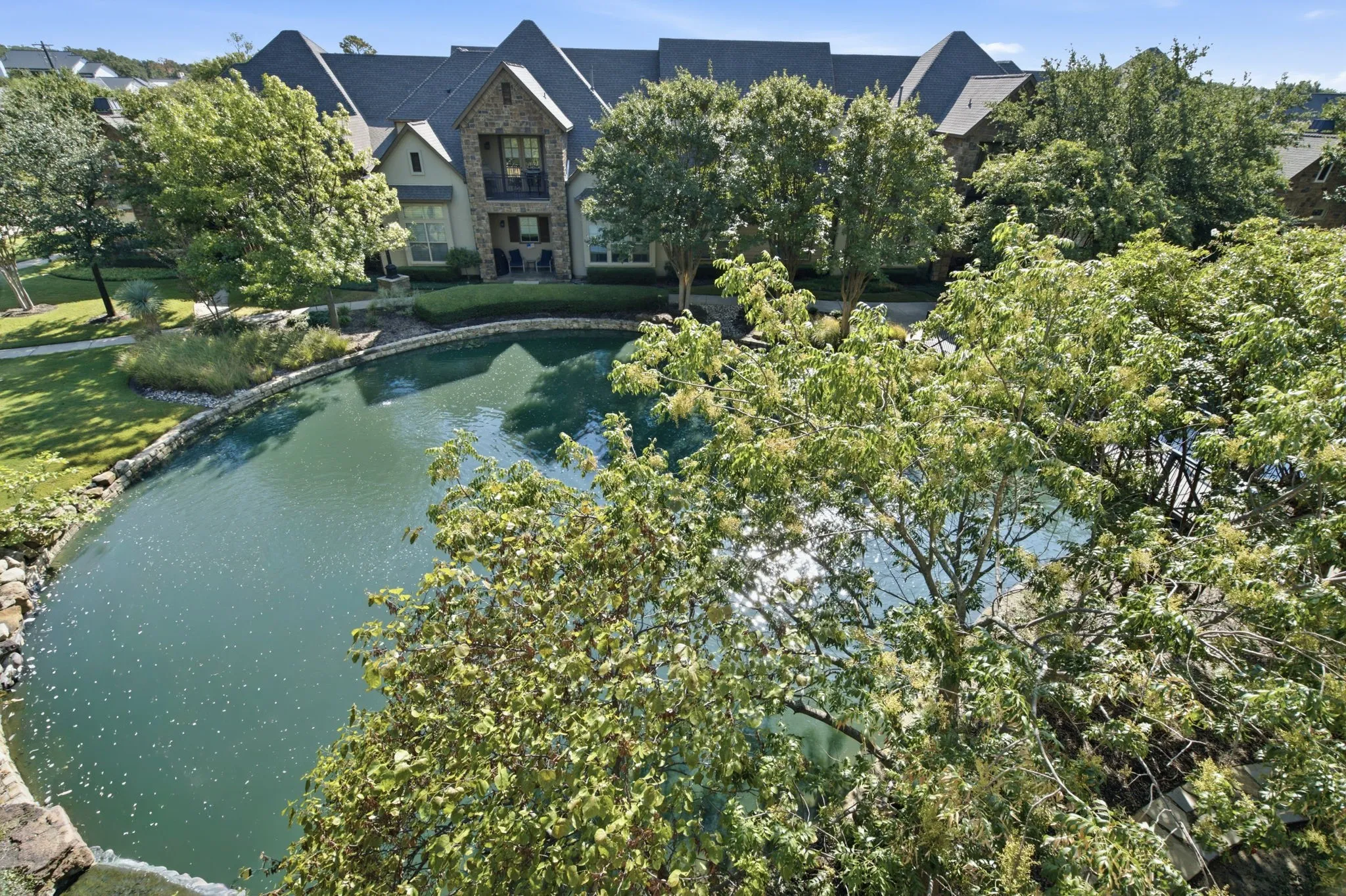Beautiful pond and fountain view from covered balcony, dining area, living area and guest bedroom.