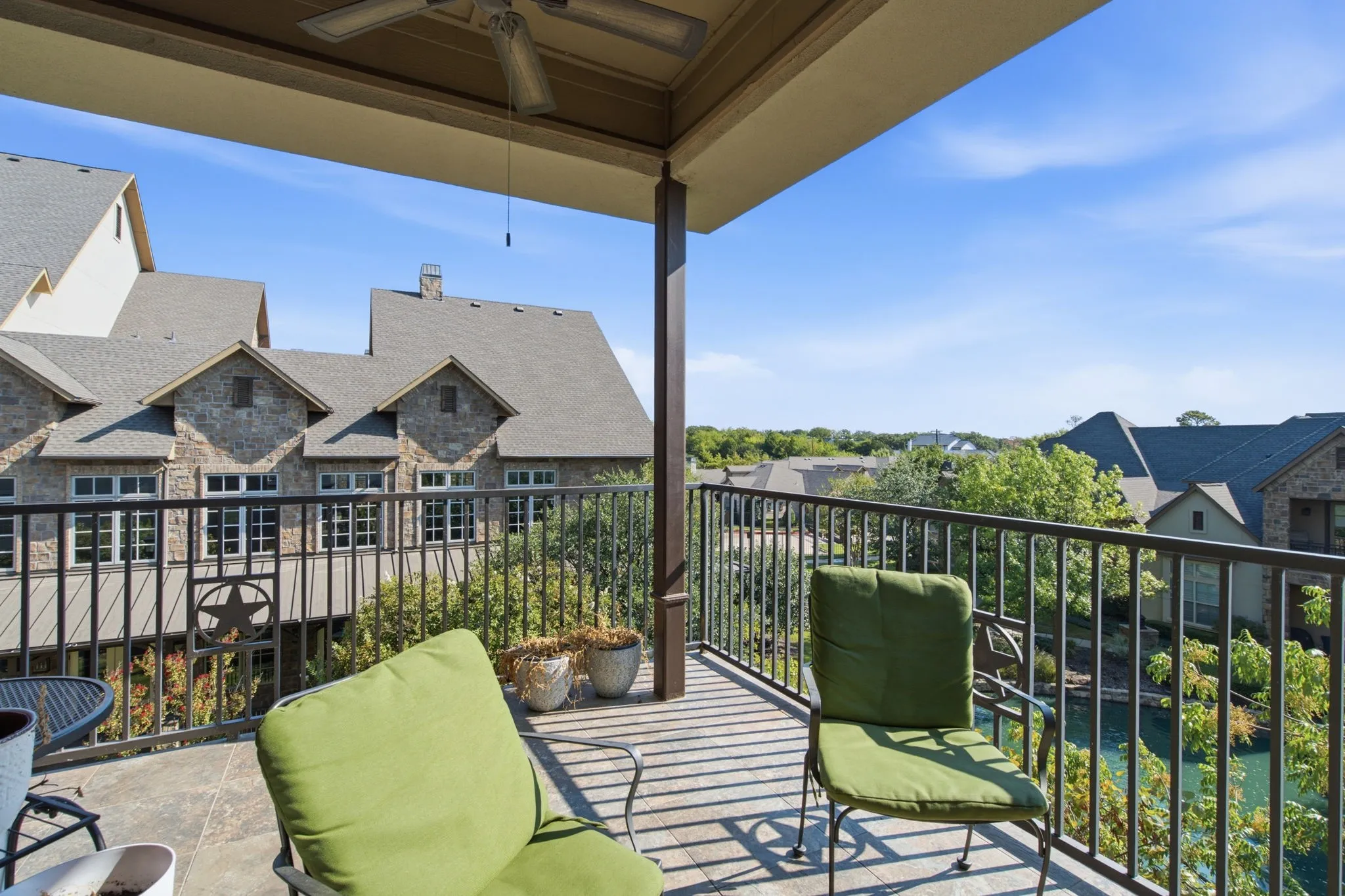 Covered balcony overlooks pond and fountain.