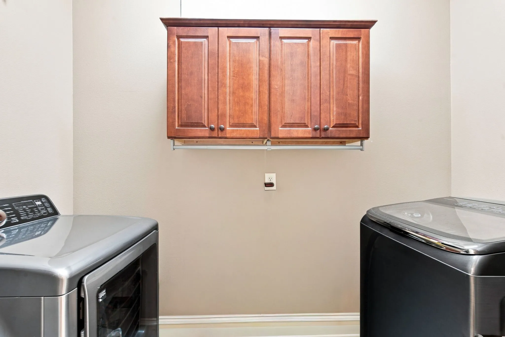 Built-in wood cabinetry with a clothes hanging rod