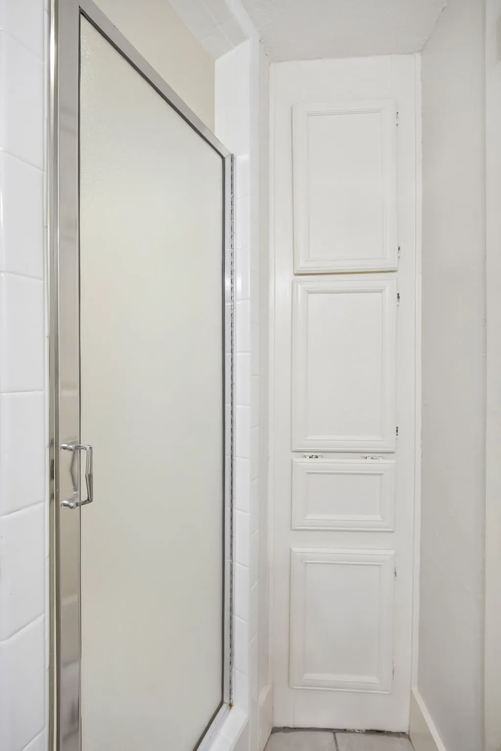 Frosted glass shower enclosure with chrome hardware