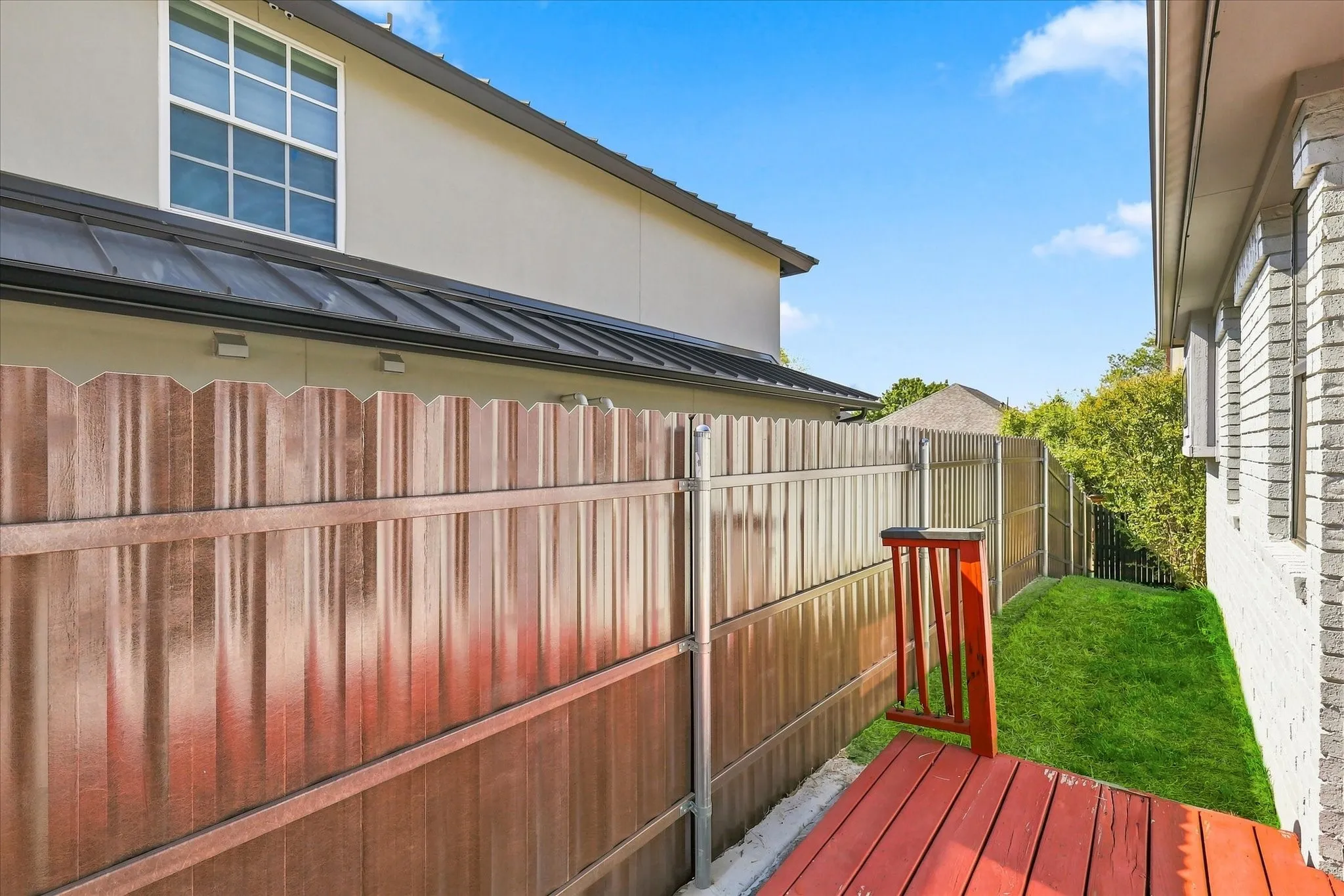 Red-stained wood decking with matching railings