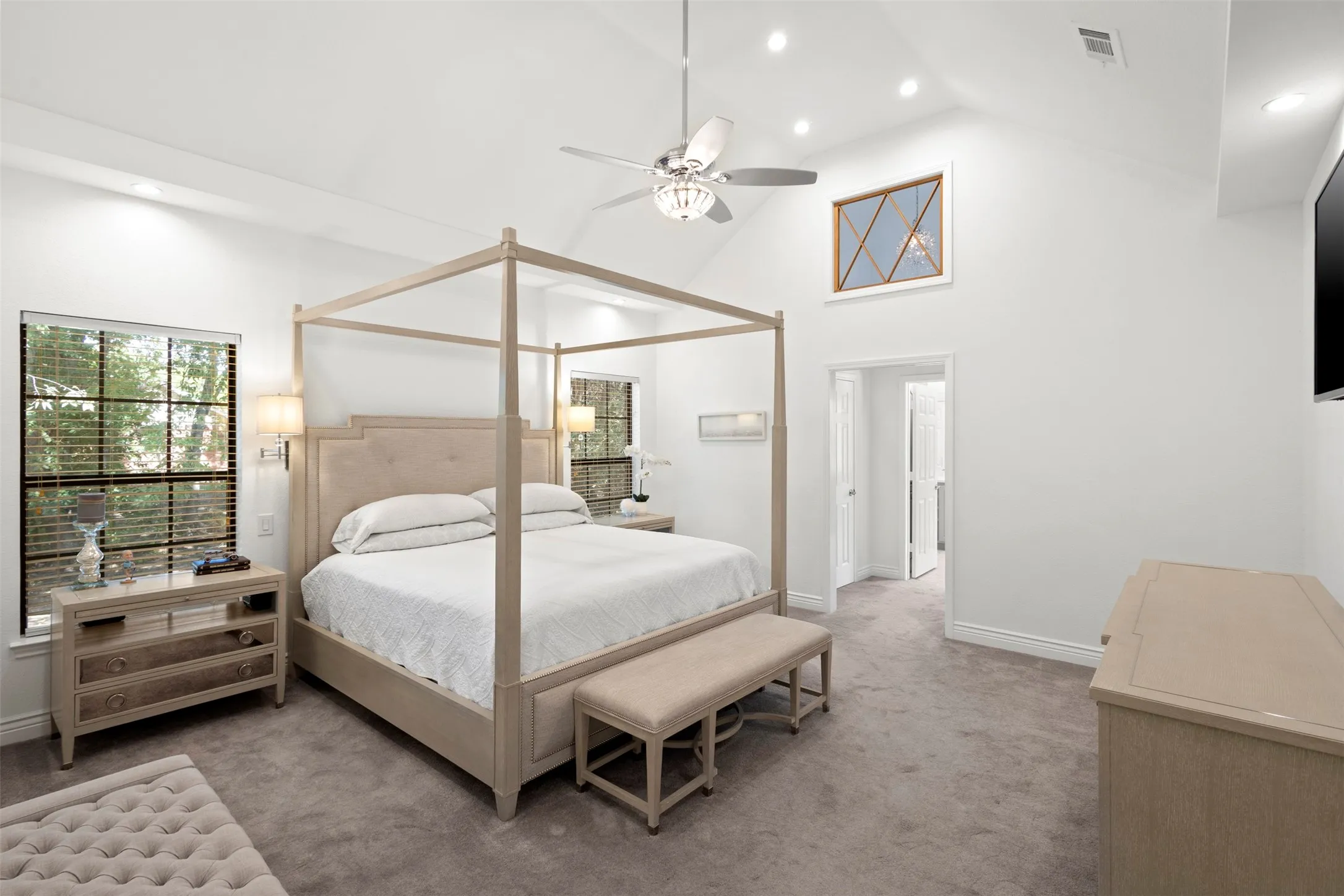 Vaulted ceiling with recessed lighting and a ceiling fan