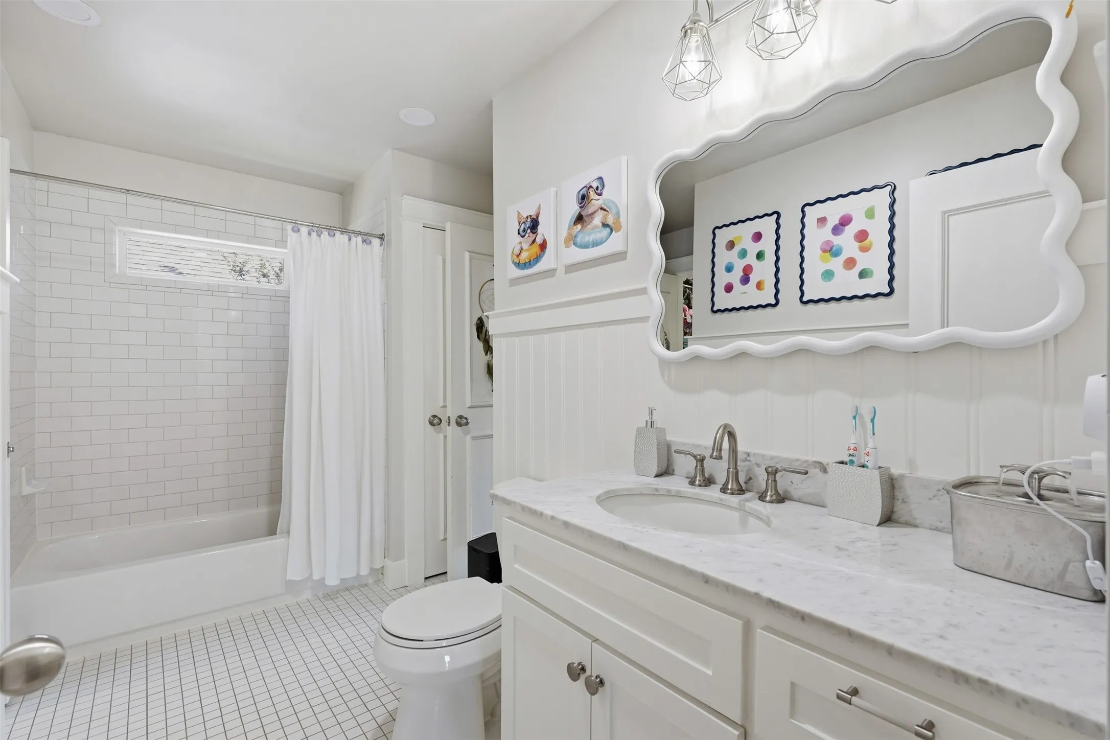 Bathroom featuring a single vanity with stone countertop, white shaker cabinetry, paneling, and a tub with subway tile surround