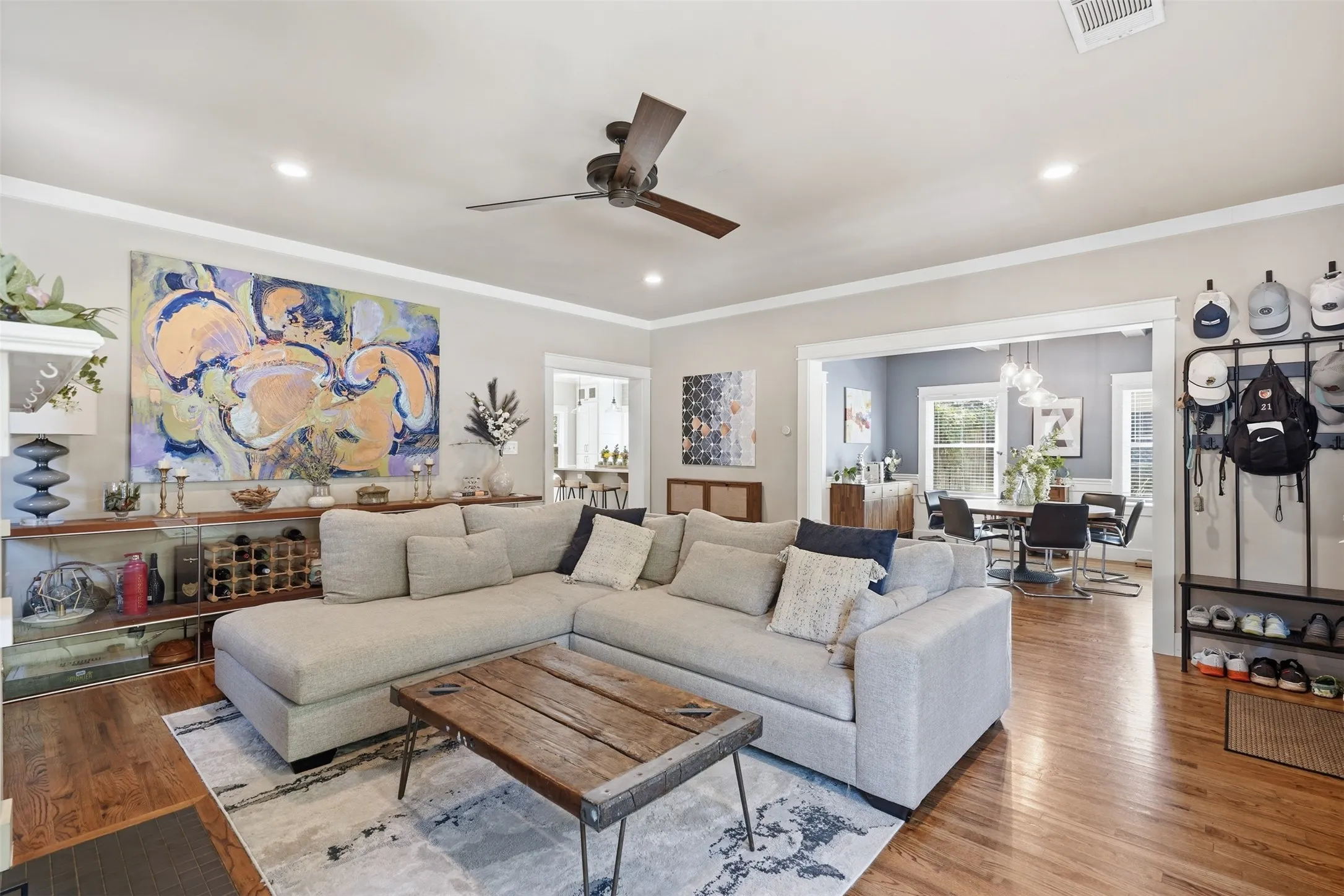 Hardwood flooring throughout, recessed lighting, crown molding, and a ceiling fan