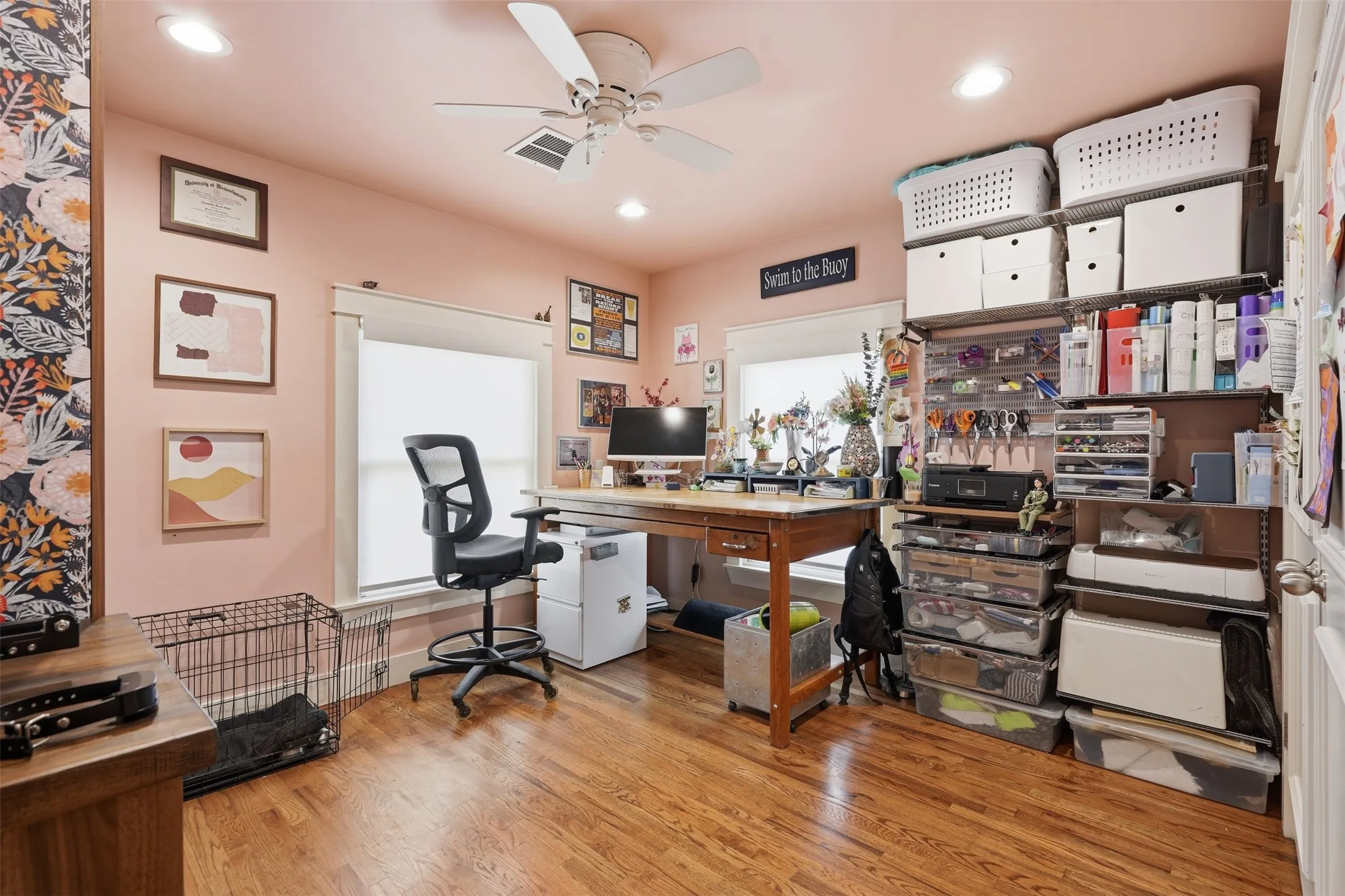 Wood-finish flooring, recessed lighting, ceiling fan, and multiple windows