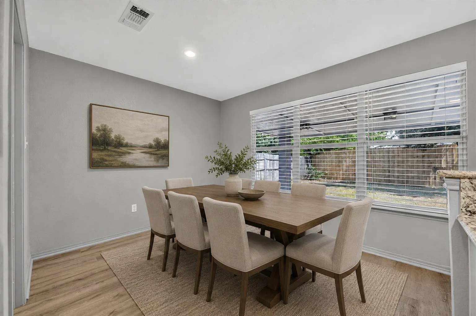 Virtually staged Recessed ceiling lighting, wood-finish flooring, and a large window with horizontal blinds