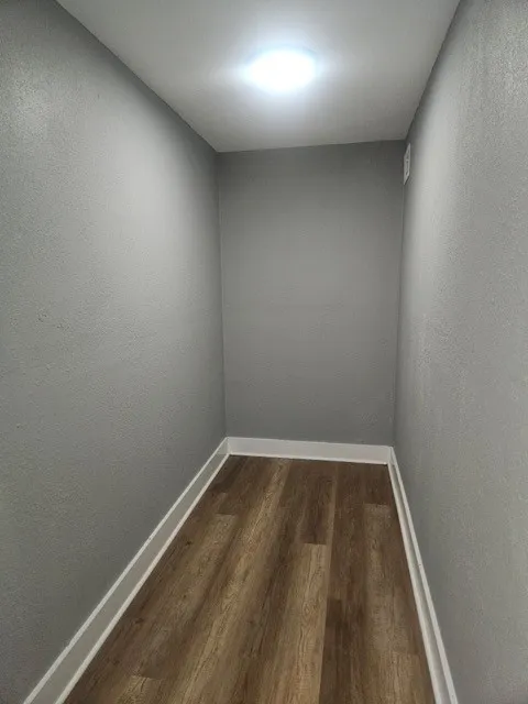 Flex space, Recessed lighting, textured walls, wood-finish flooring, and white trim