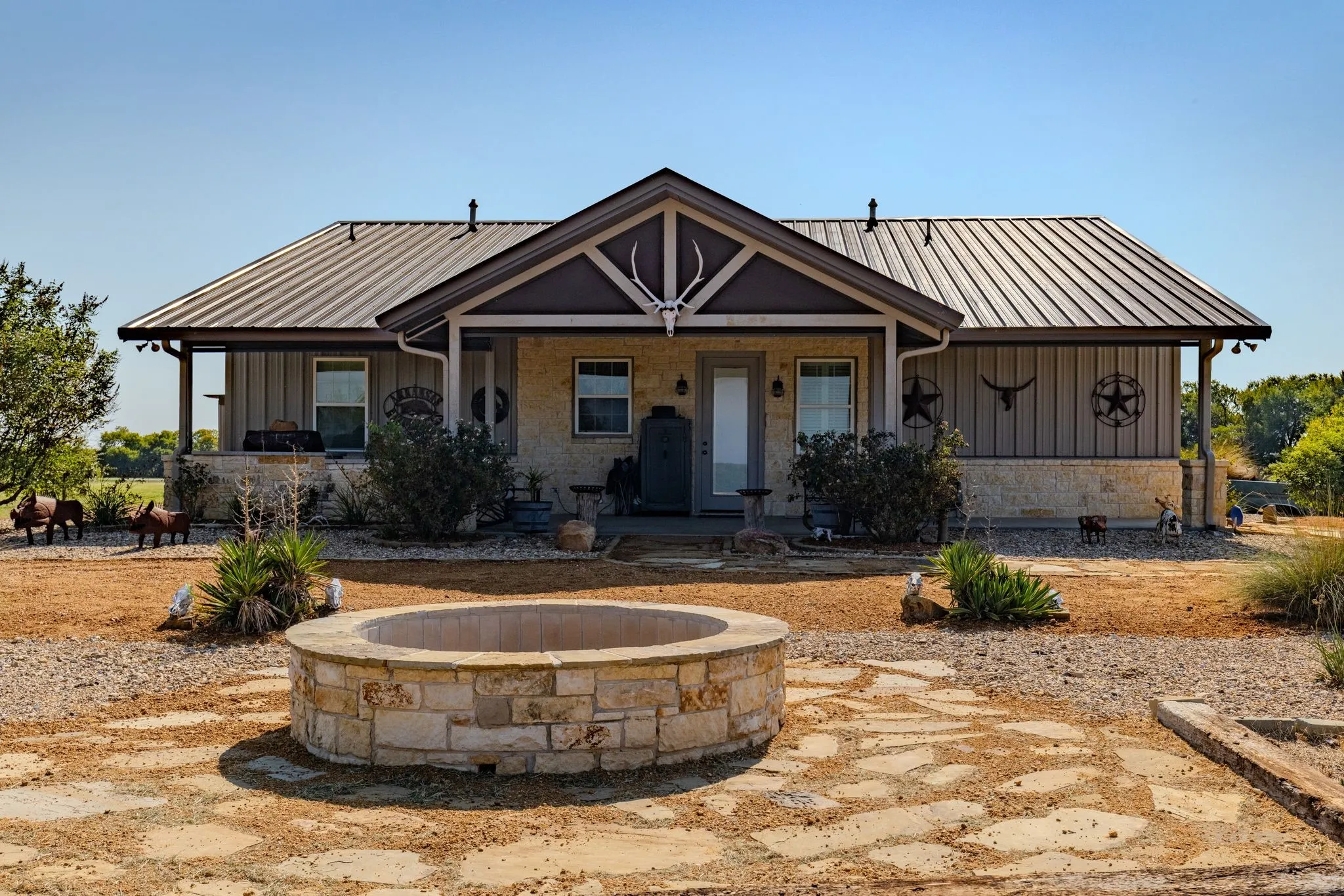 Covered back patio with outdoor kitchen and firepit