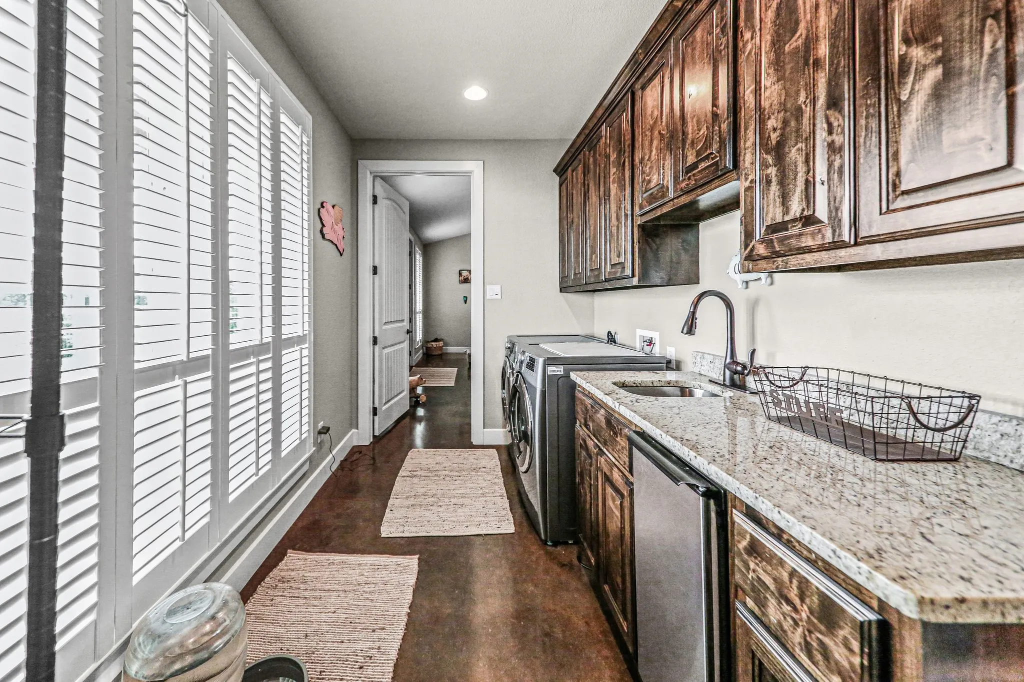Laundry room with additional storage and sink