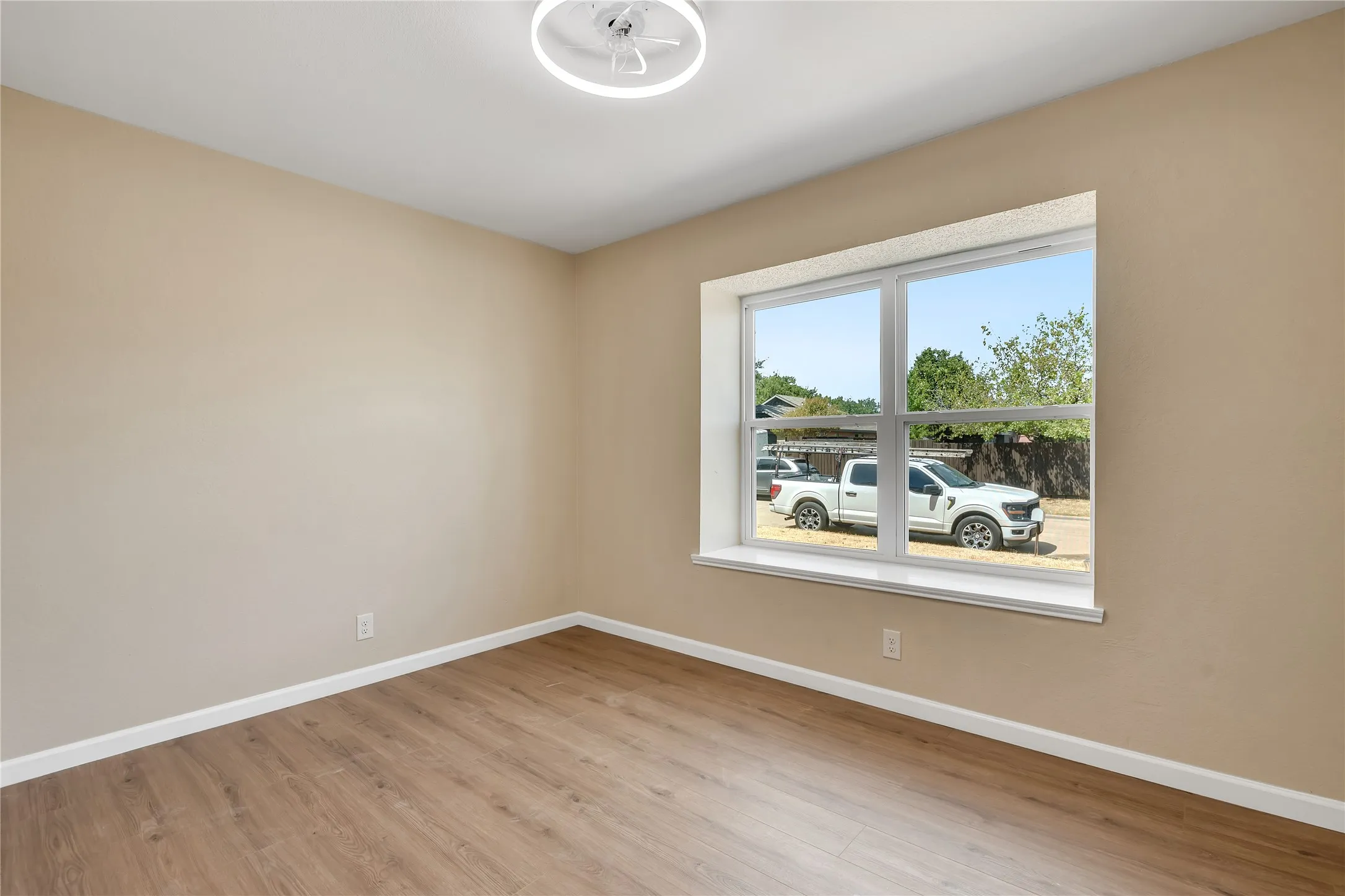 Neutral wall tones with wood-finish flooring