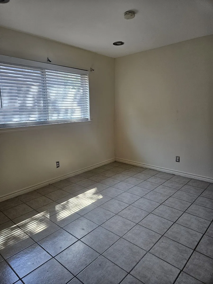 Tile flooring, recessed lighting, and a window with blinds