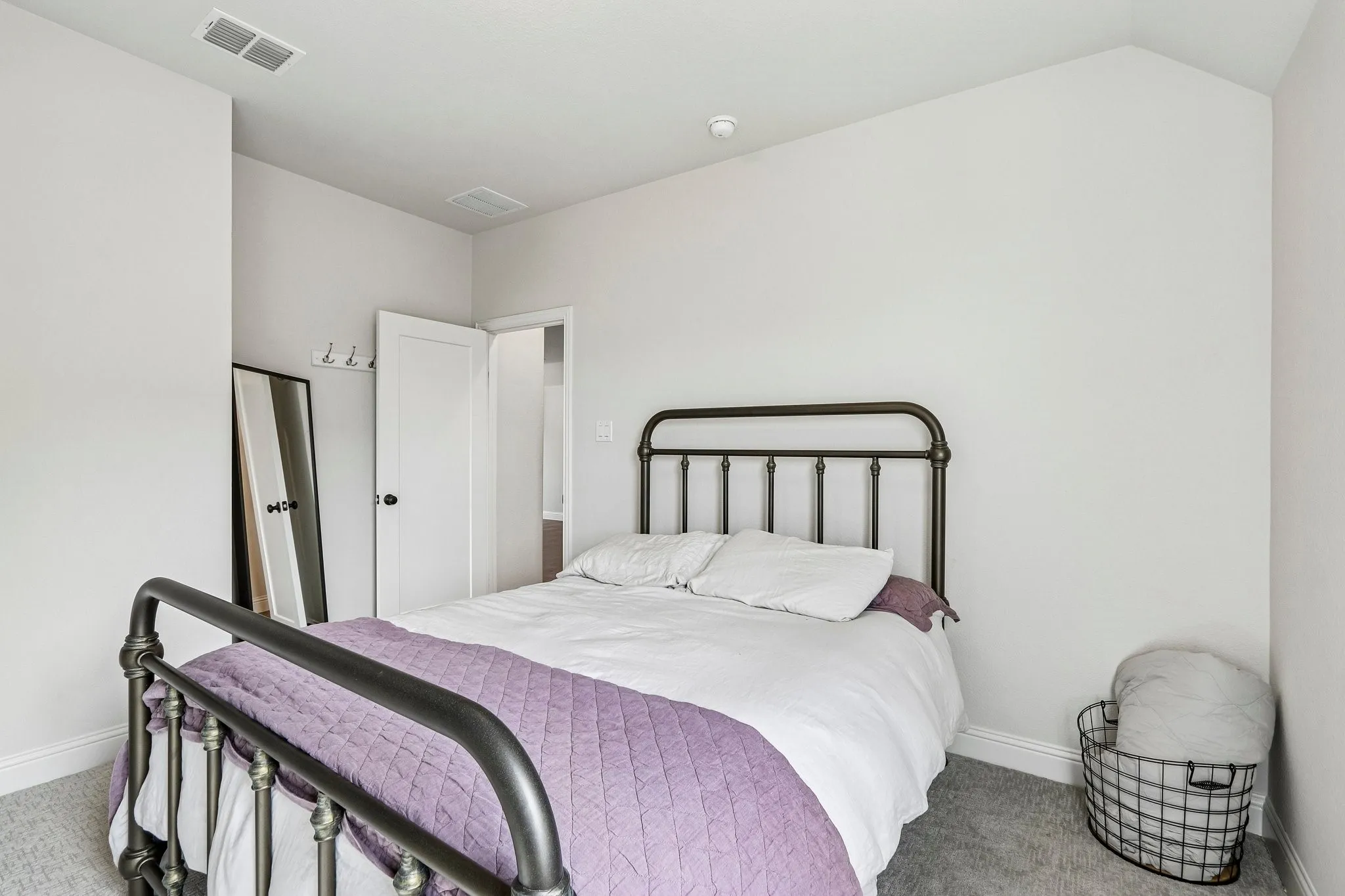 Carpeted room with bright white walls and a white paneled door