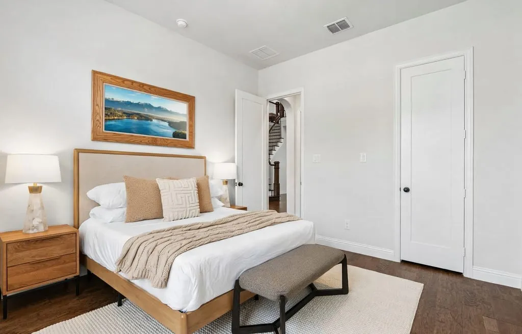 Hardwood-finish flooring, white walls, and a recessed ceiling light