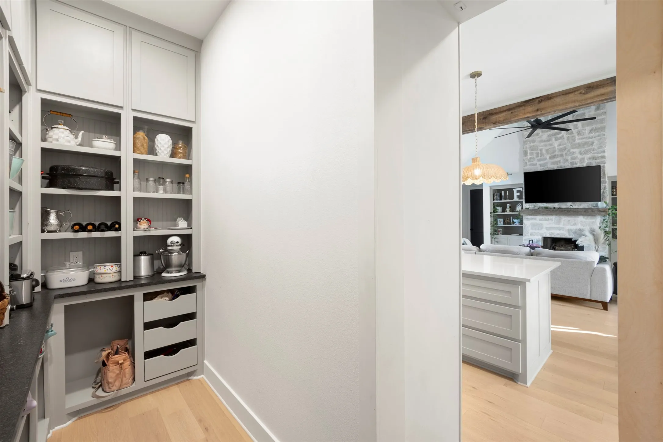 Integrated pantry shelving with grey cabinetry and pull-out drawers