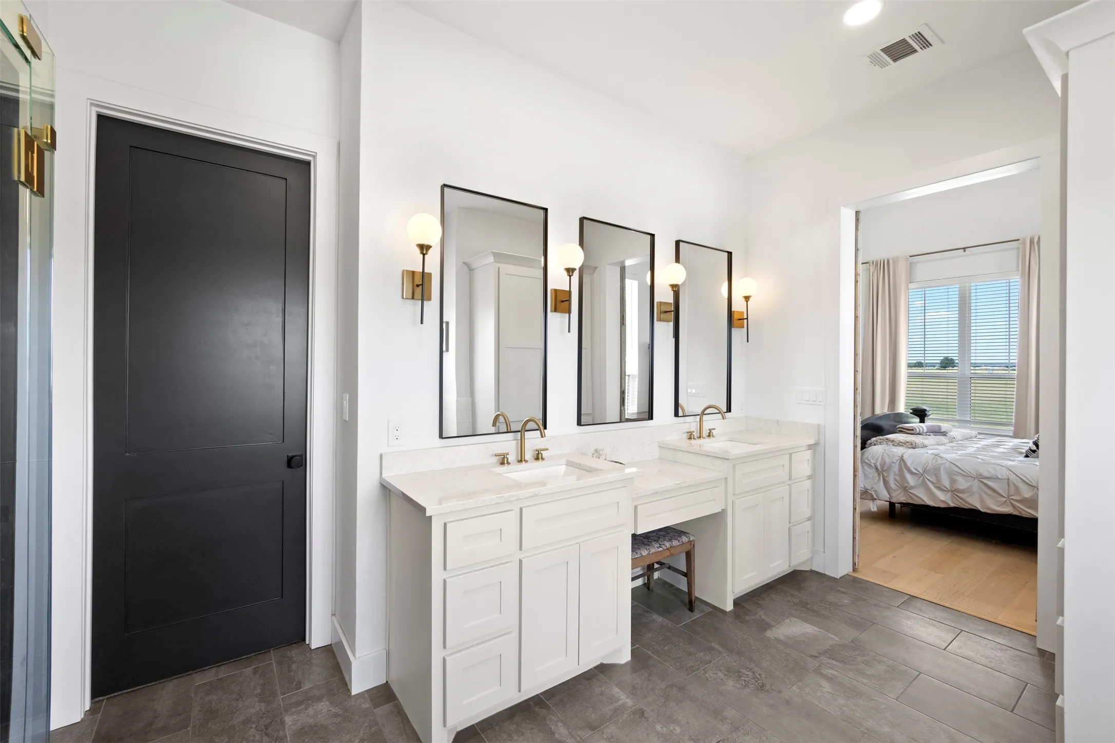 Dual vanity with undermount sinks, white cabinetry, and light-toned countertops