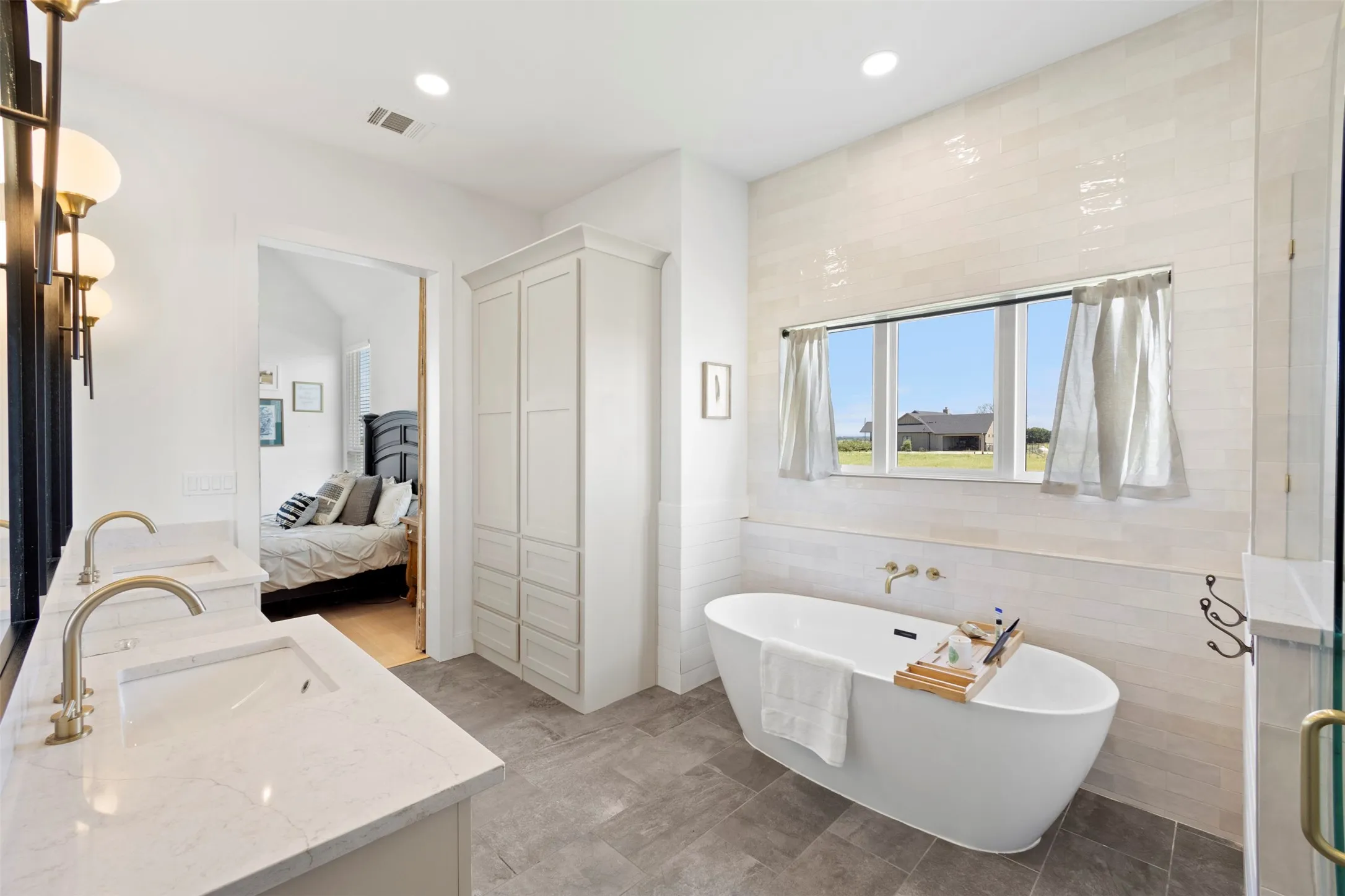 Dual vanity with undermount sinks and brushed gold fixtures