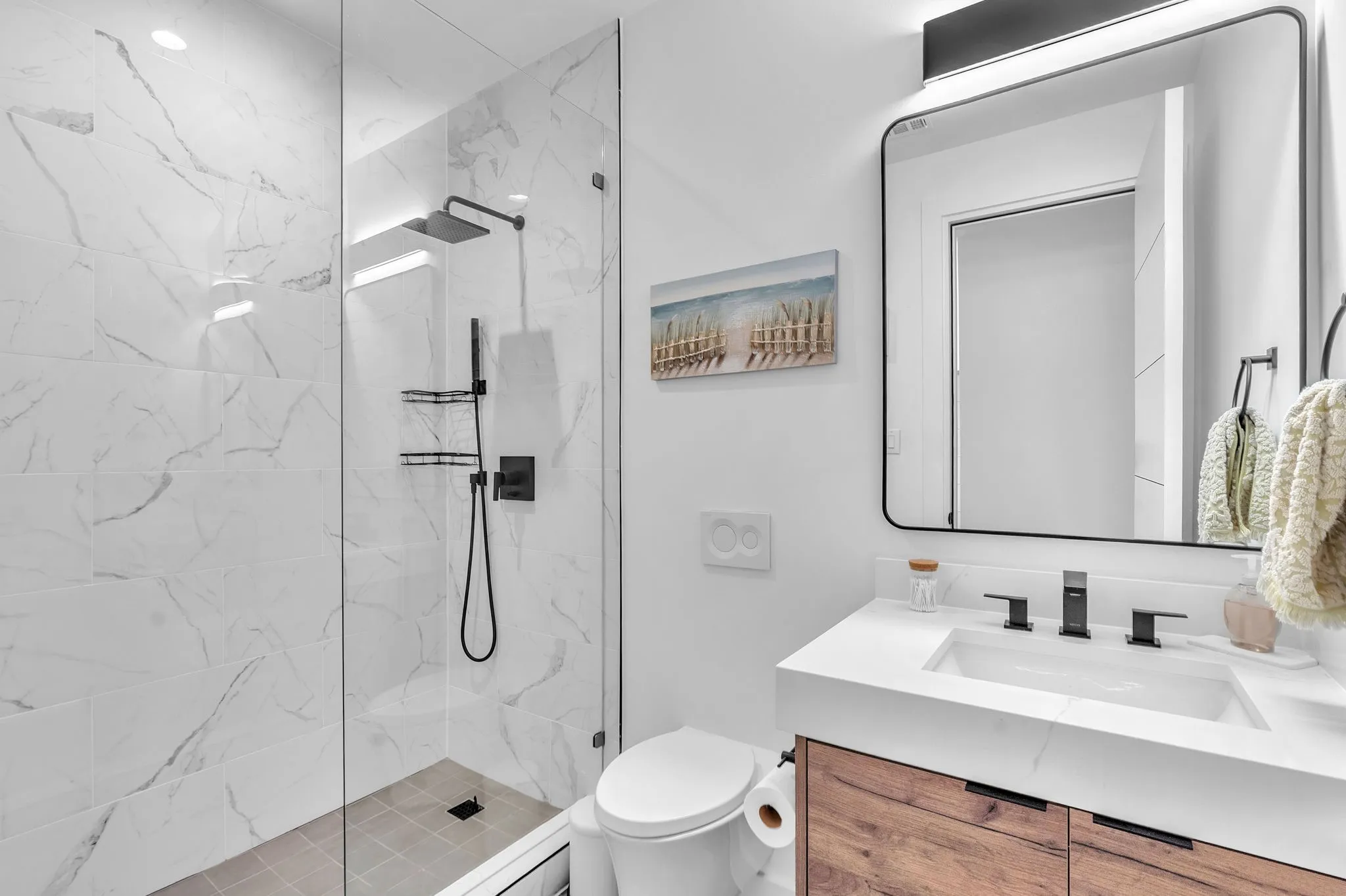 Contemporary bathroom featuring a walk-in shower with clear glass enclosure and matte black fixtures