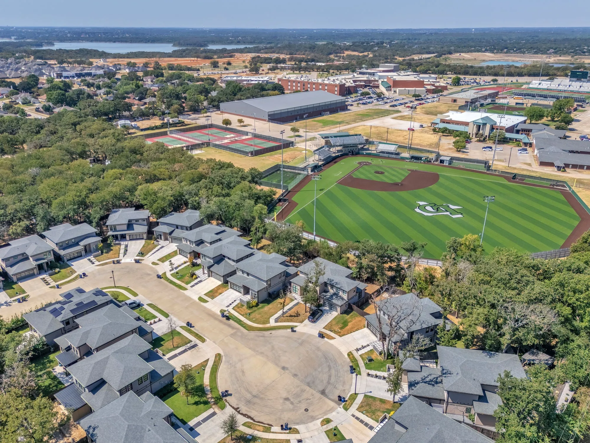 Cul-de-sac community featuring contemporary residences with dark gray roofs