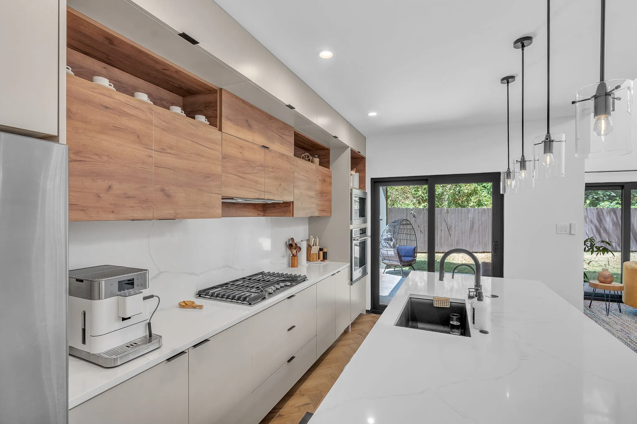 Contemporary kitchen featuring wood-finish cabinetry, white countertops, and a gas cooktop