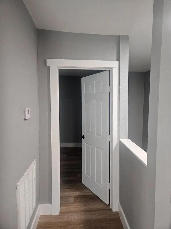 Wood-finish flooring throughout, complemented by light gray walls and white trim