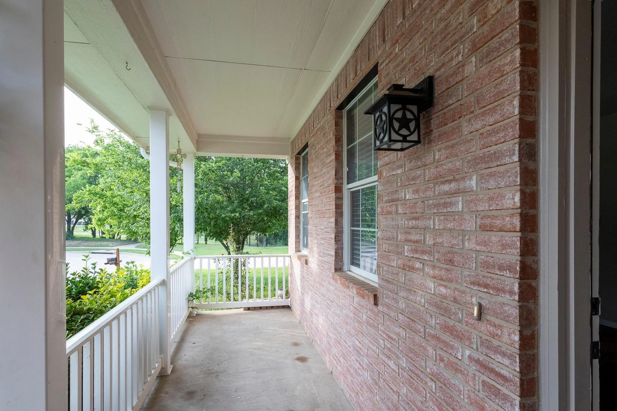 Covered front porch with white railing