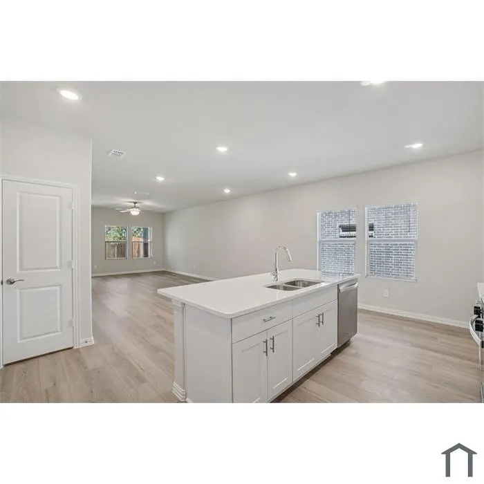 Kitchen island with an undermount double-basin sink and stainless steel faucet
