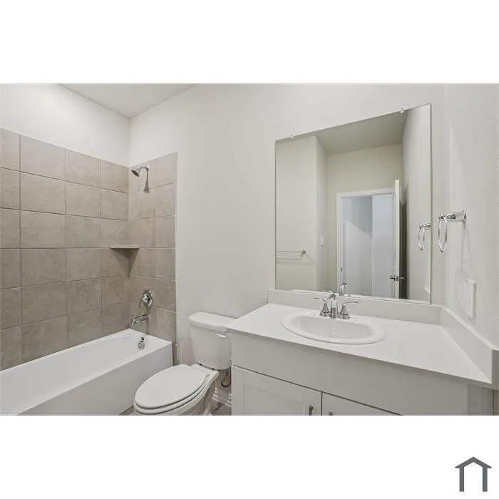 White vanity with a rectangular basin sink, chrome faucet, and expansive wall mirror